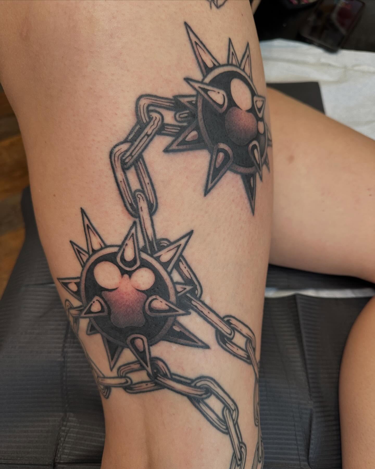 Chains and spiked orbs black and grey tattoo on the forearm by Megon Shore, Seattle, Washington