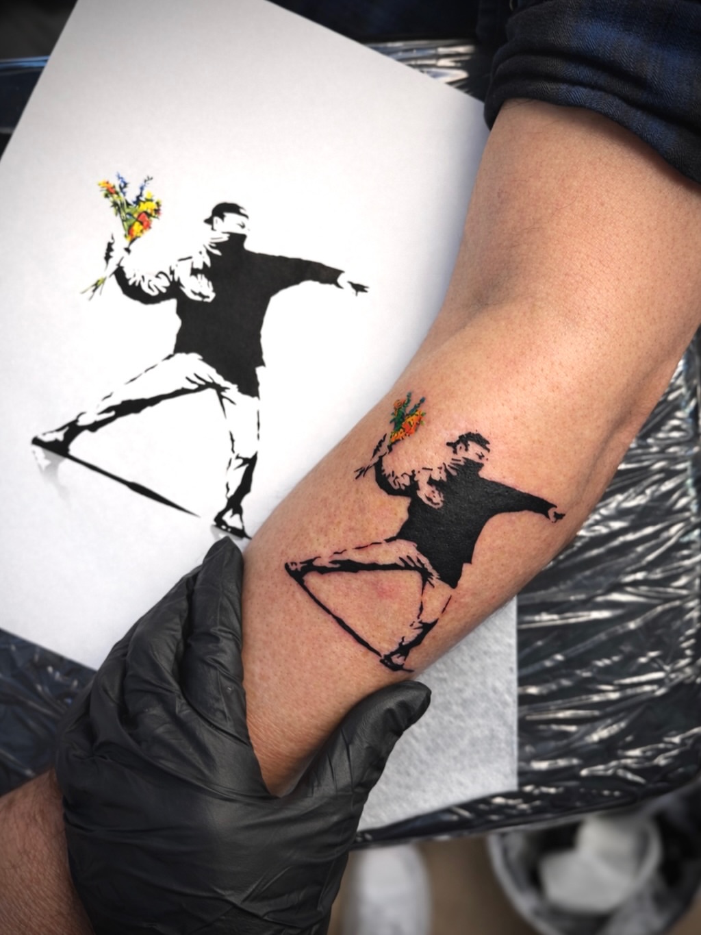 Flower thrower black and grey tattoo on the forearm by Aristova Anastasia