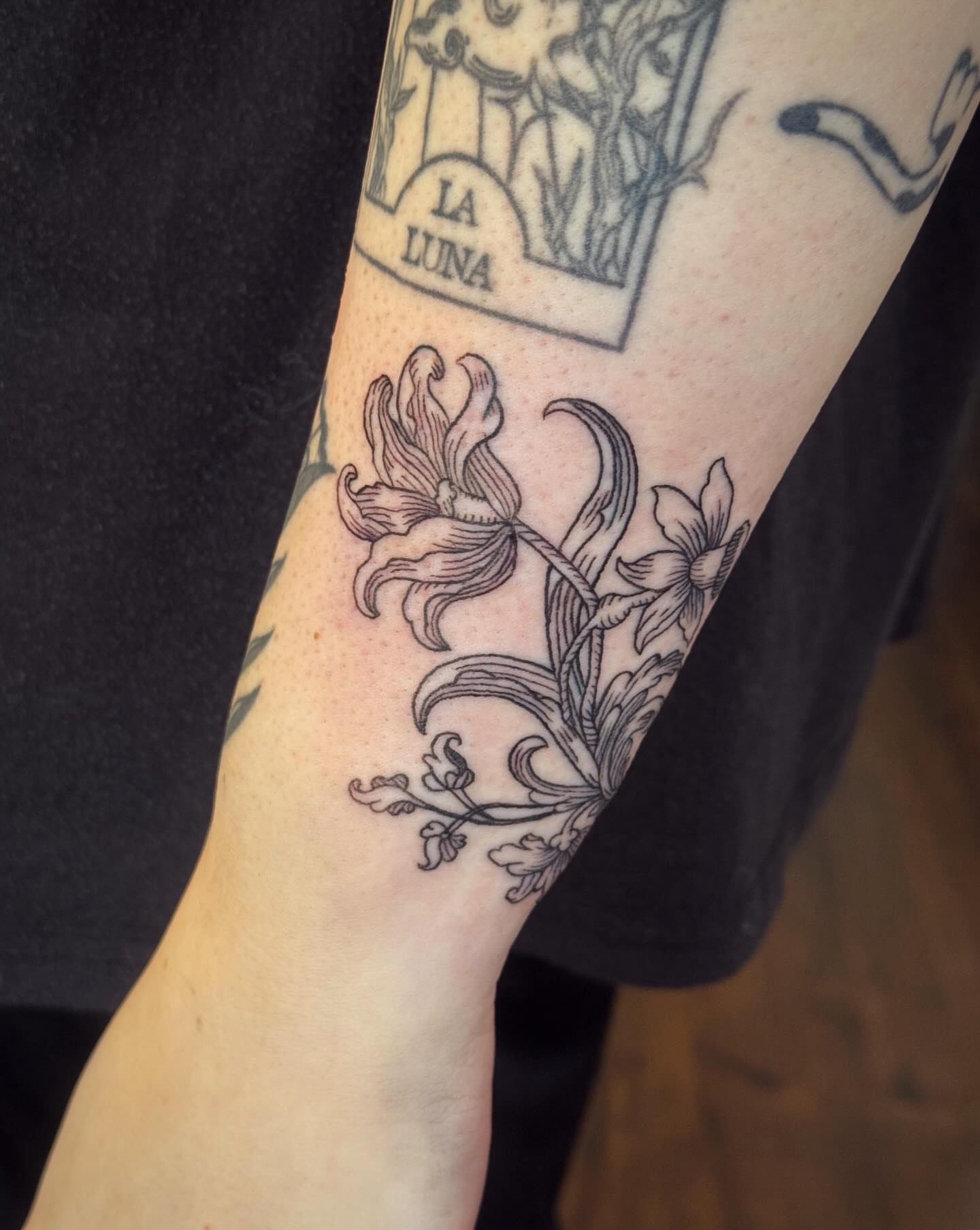Lilies black and grey tattoo on the forearm by Luna Enriquez⚡️, Portland, Oregon