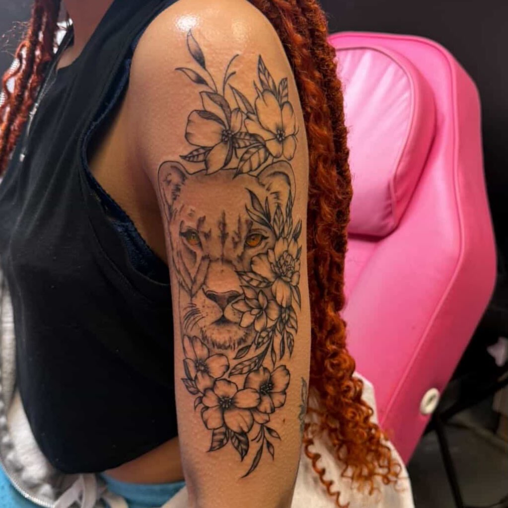 Lion with flowers realism tattoo on the upper arm by Big Mar, Rocky Hill, Connecticut