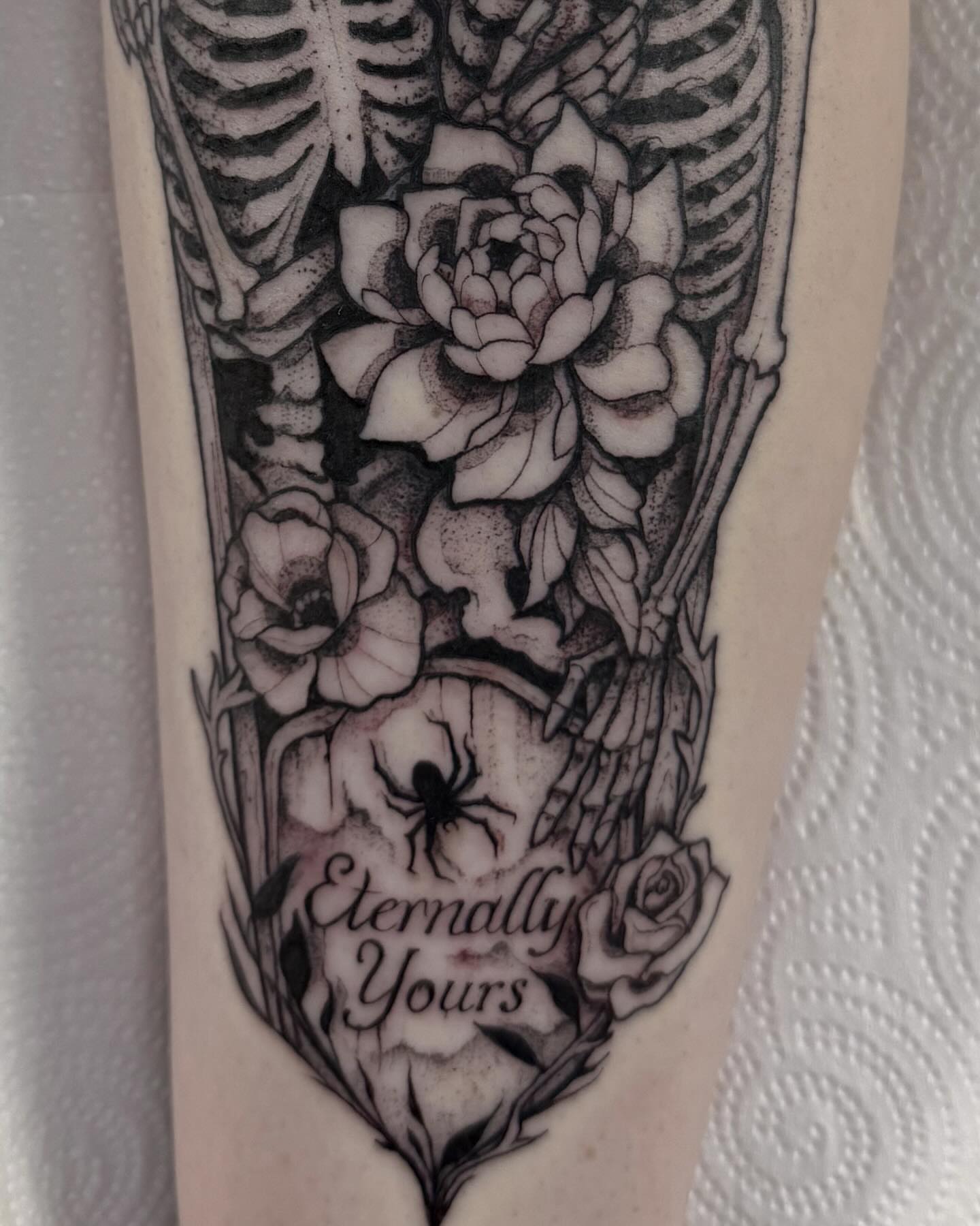 Skeleton with flowers realism tattoo on the forearm by amanda malia wega