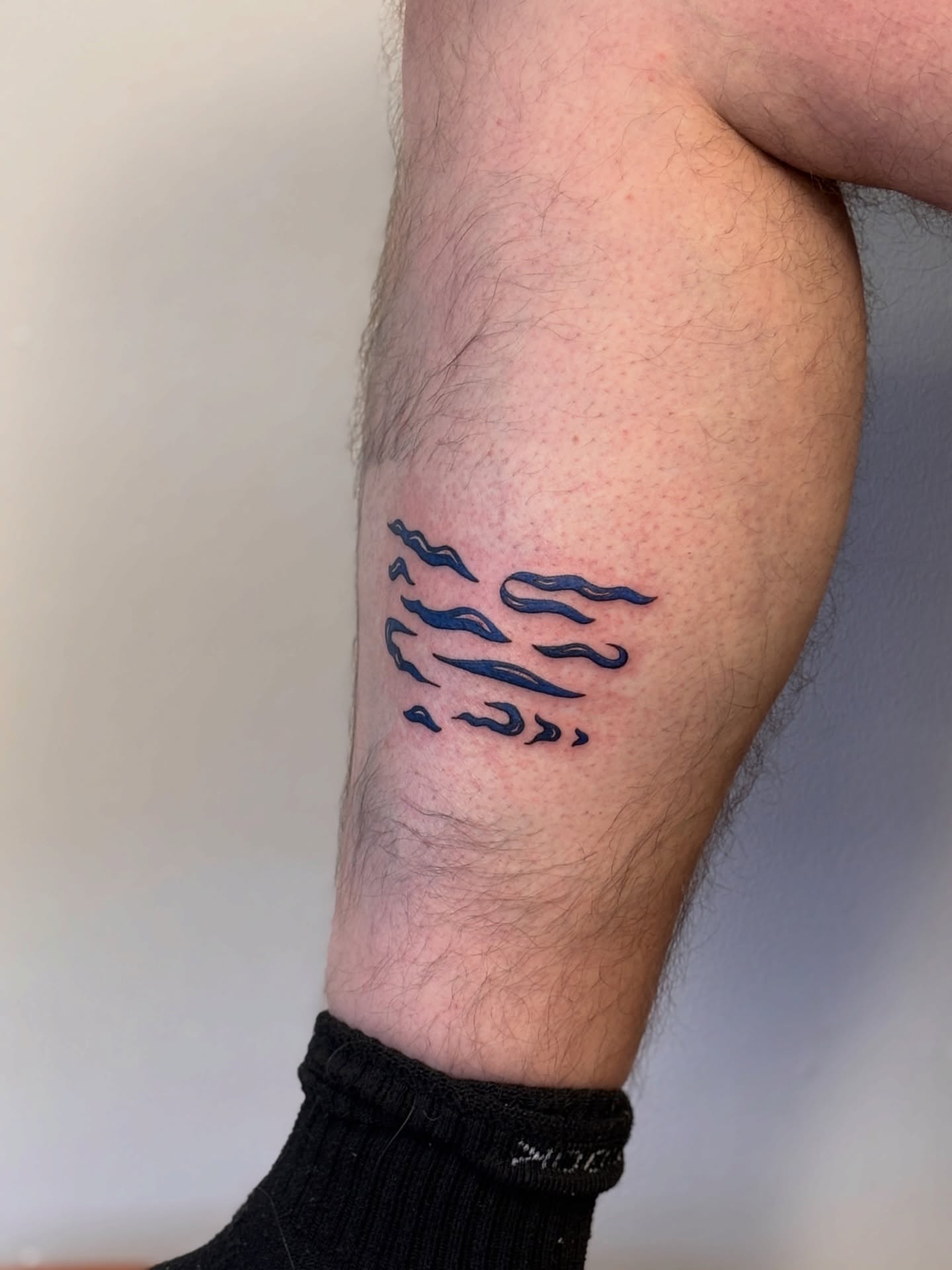 Wind minimalist tattoo on the forearm by Maddie