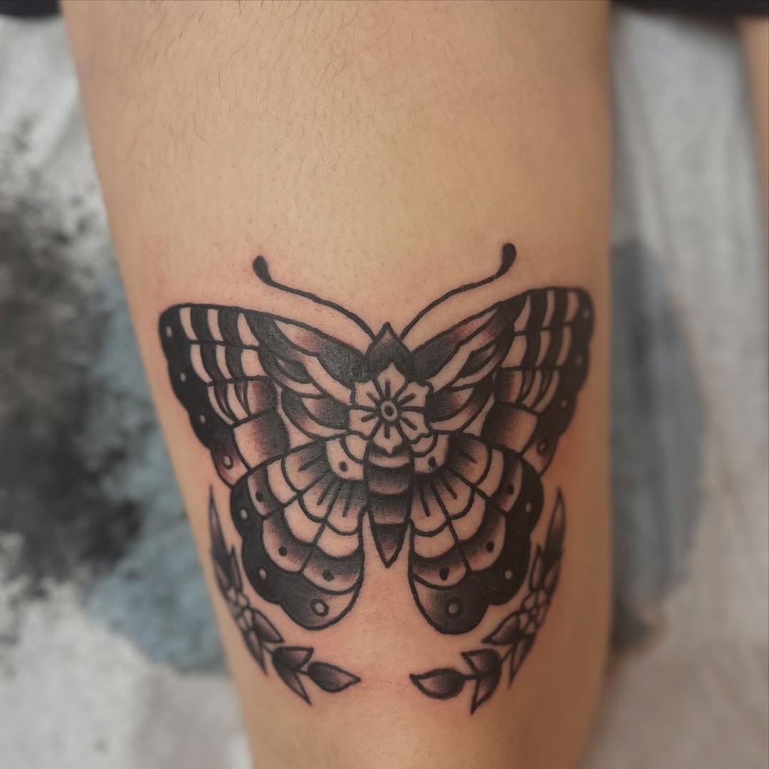 Butterfly with floral elements fine line tattoo on the forearm by norawillstattoo