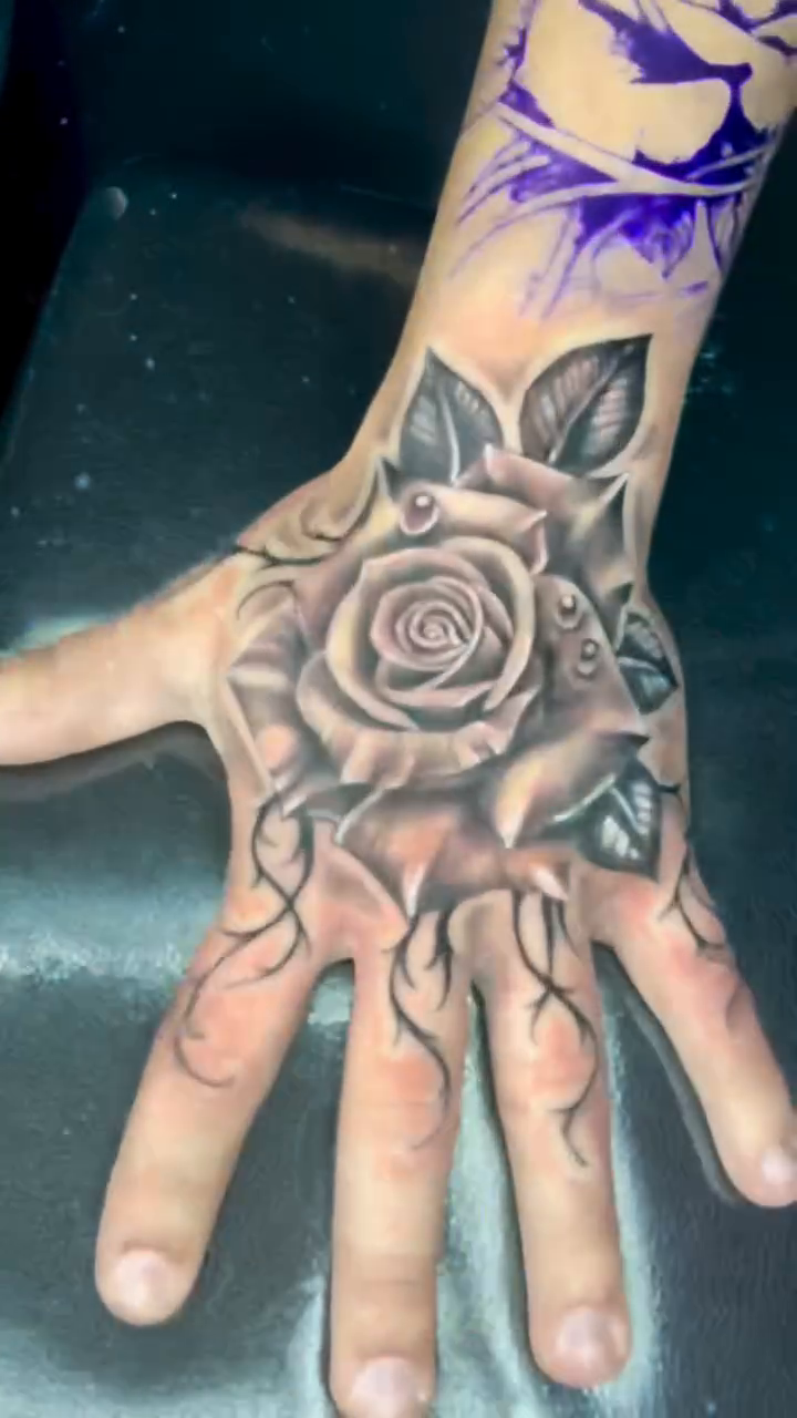 Rose and vines on hand surrealism tattoo on the hand by Inkman Parson