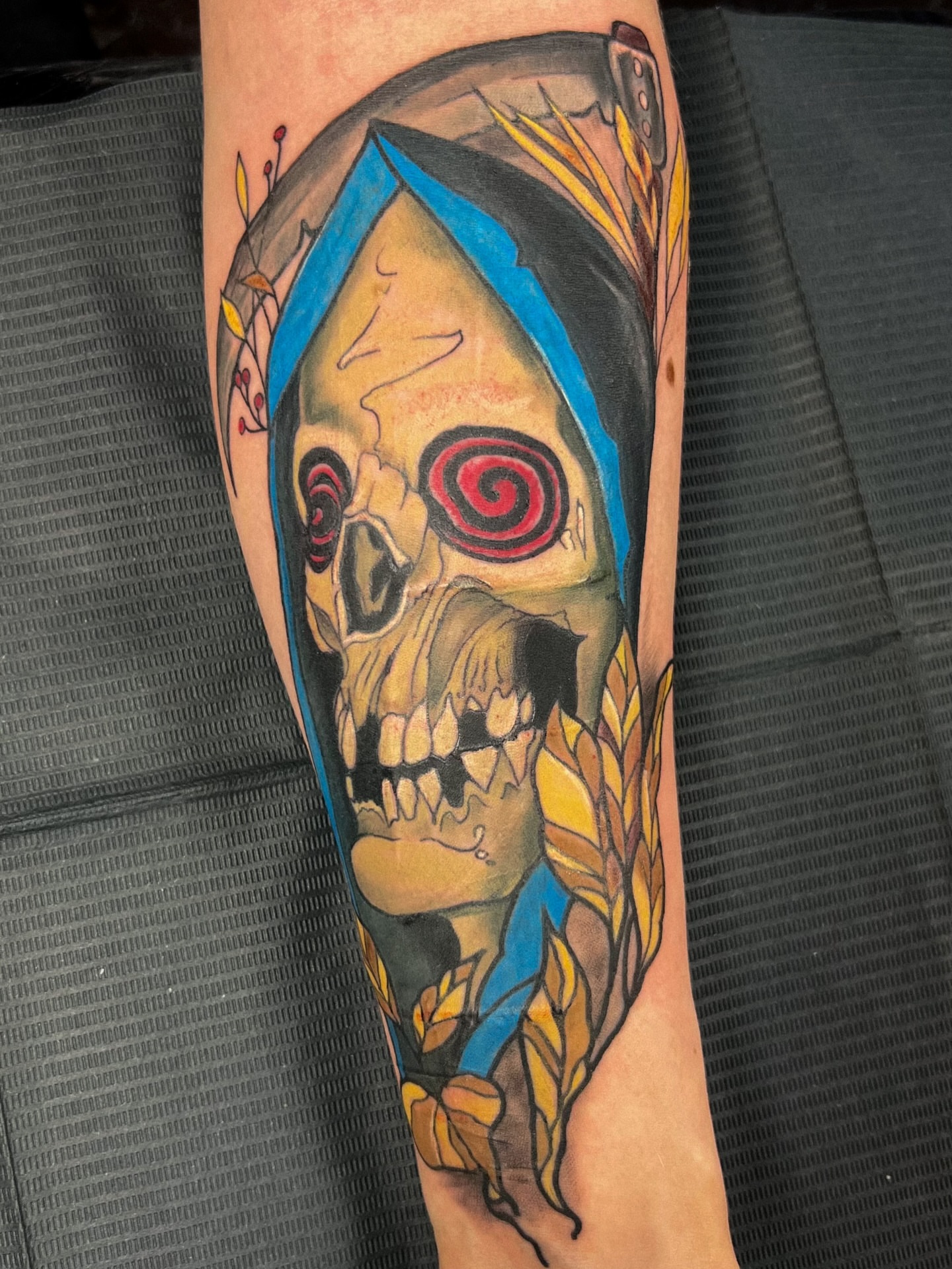 Skull with spiral eye neo-traditional tattoo on the forearm by Asap tattoo