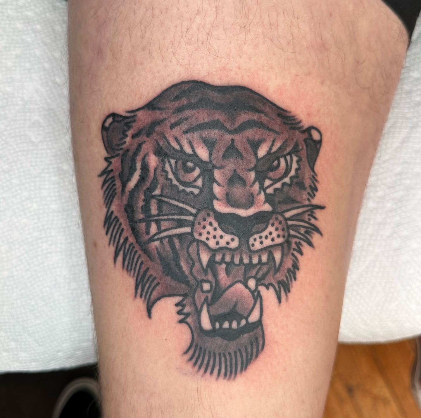 Tiger head black and grey tattoo on the forearm by Brock Johnson