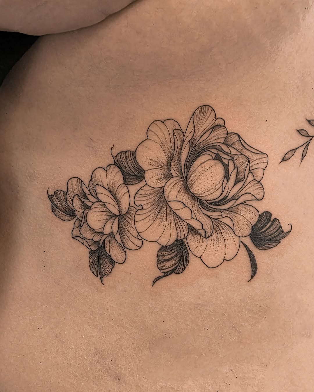 Peonies dotwork tattoo on the ribs by Richmond tattoo shop, Richmond, Texas