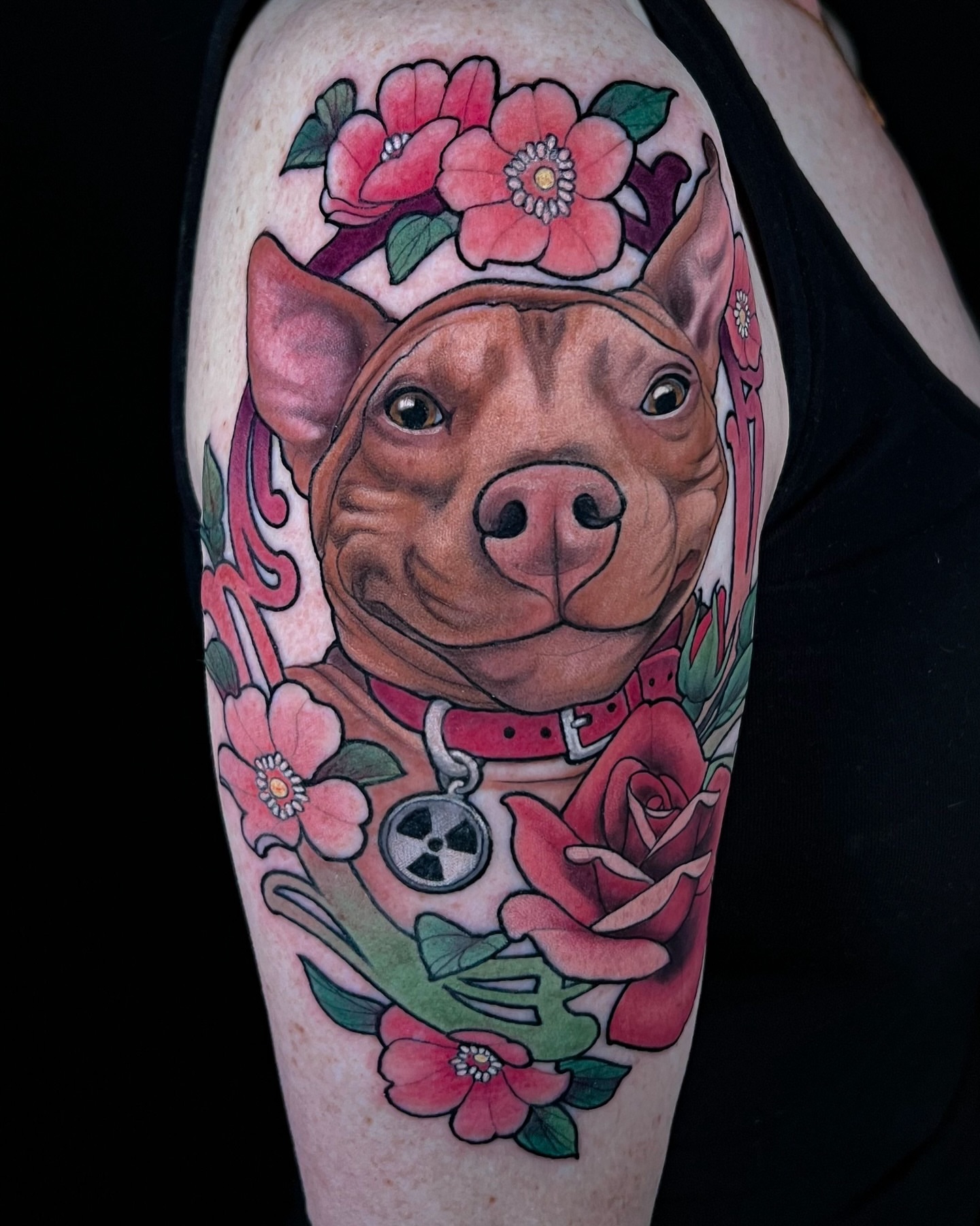 Pitbull with flowers realism tattoo on the forearm by Hannah Steele