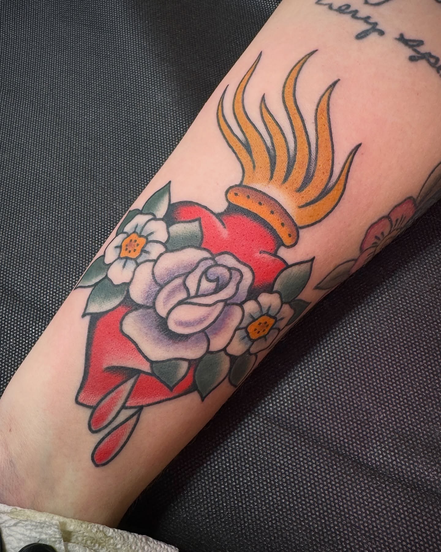 Flaming heart with roses American traditional tattoo on the forearm by Tannis - Traditional Tattoos in Richmond, VA, Richmond, Virginia
