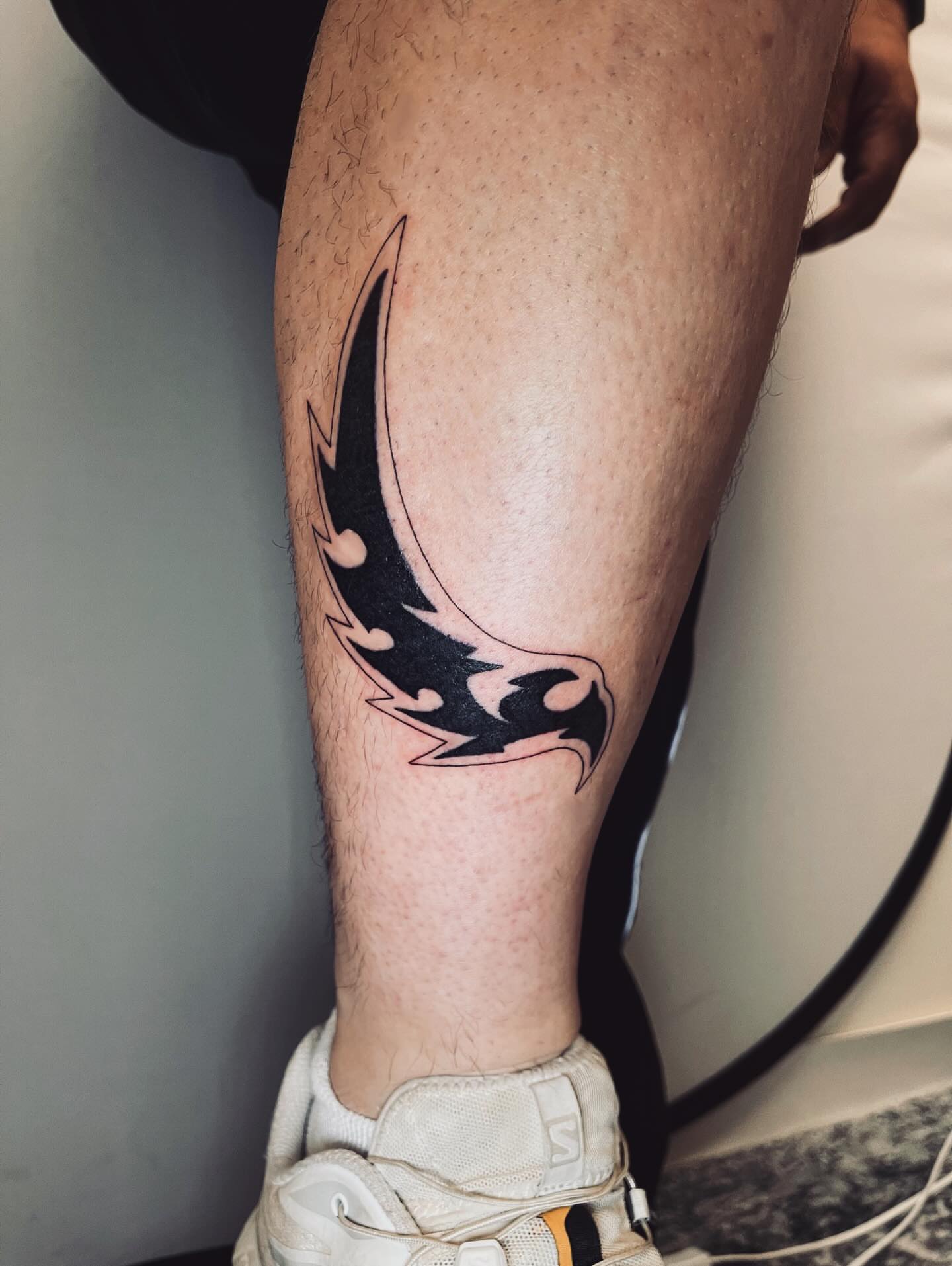 Flame black and grey tattoo on the calf by vivian