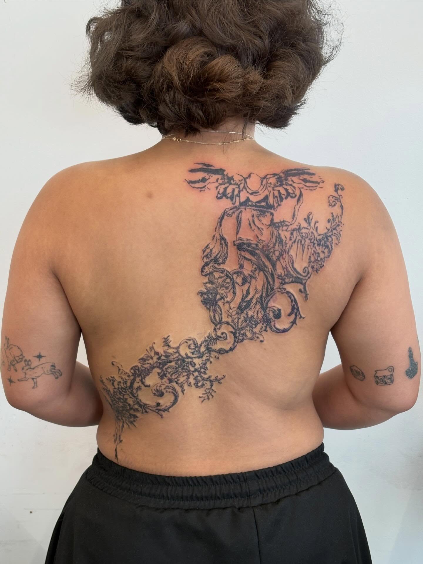Mythical creature black and grey tattoo on the back by madeline