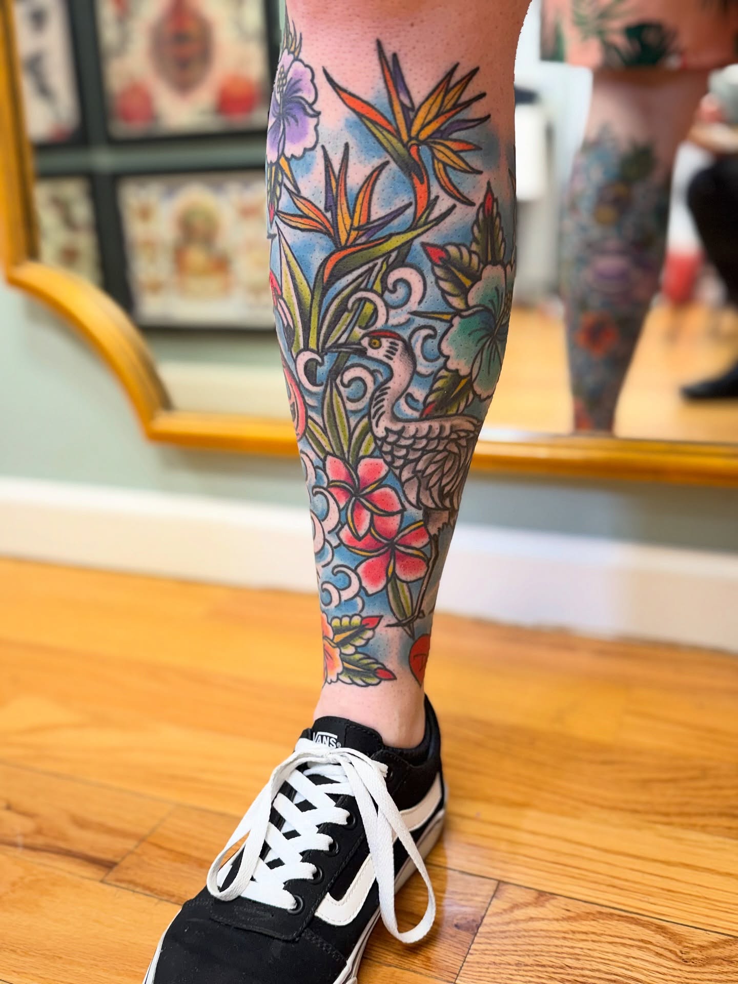 Bird and floral American traditional tattoo on the calf by Shannon Pagliarini