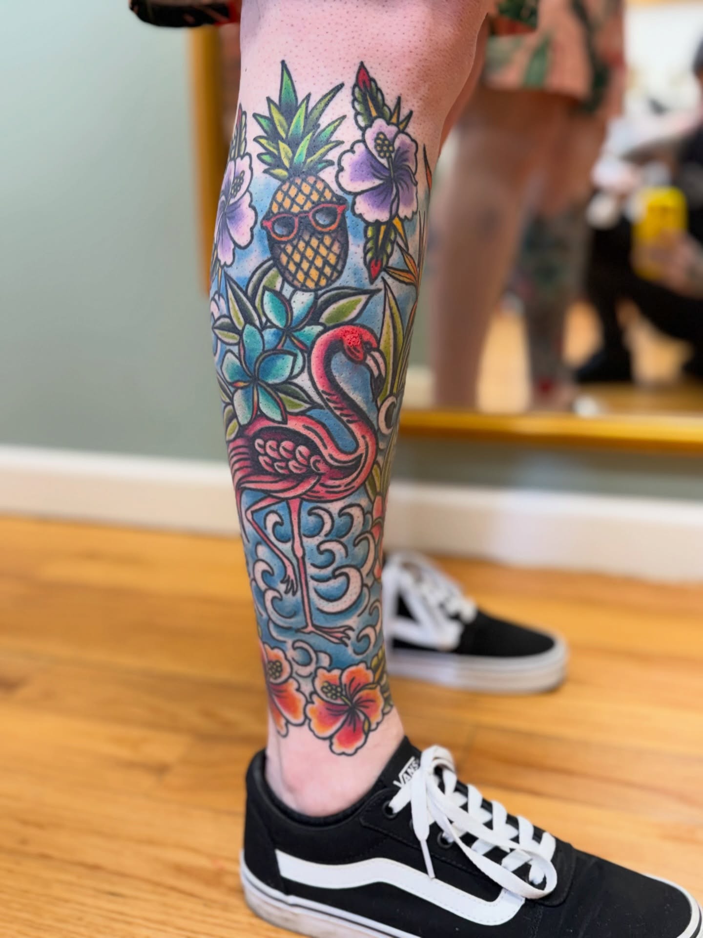 Flamingo and tropical flowers American traditional tattoo on the leg by Shannon Pagliarini