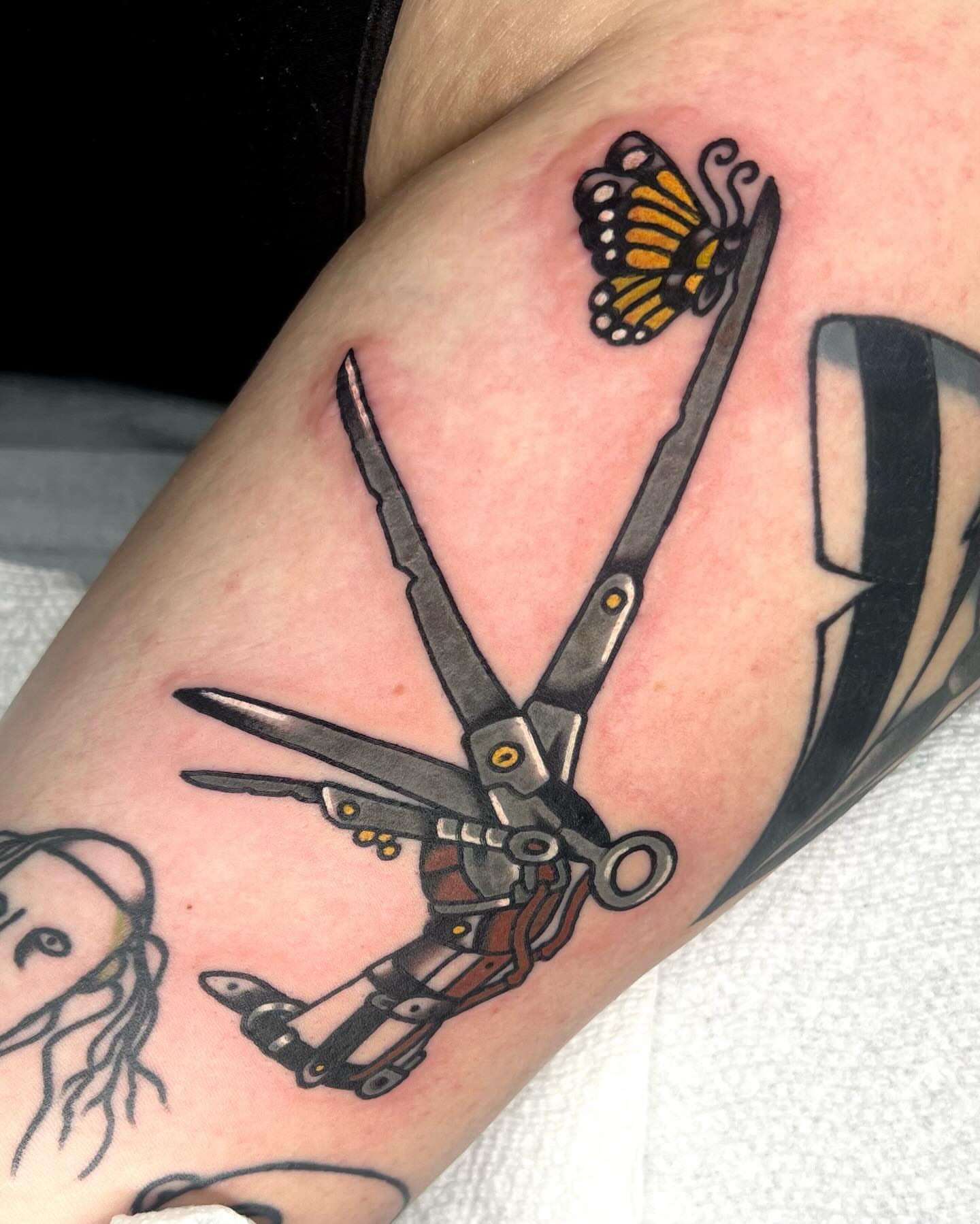 Scissors and butterfly American traditional tattoo on the forearm by 💧cry Bby💧