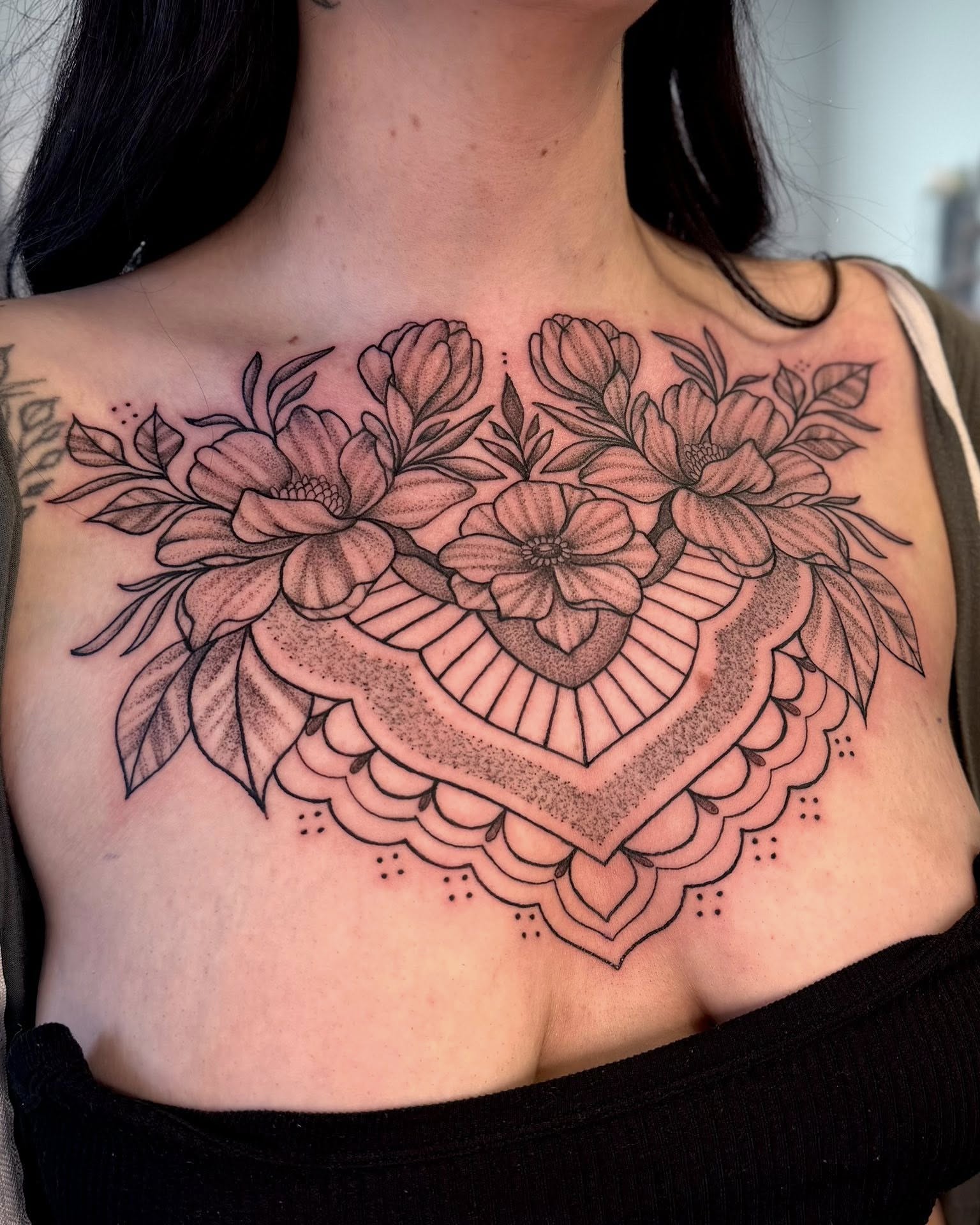 Floral heart dotwork tattoo on the chest by Eden Rose, Kalama, Washington