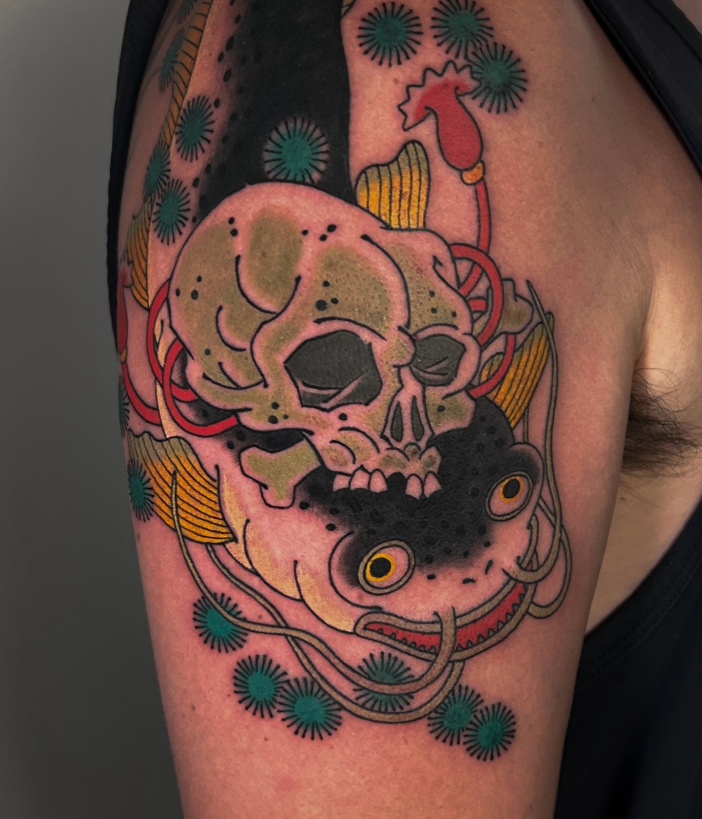 Skull and fish American traditional tattoo on the shoulder by zak brochu, Windsor, Ontario