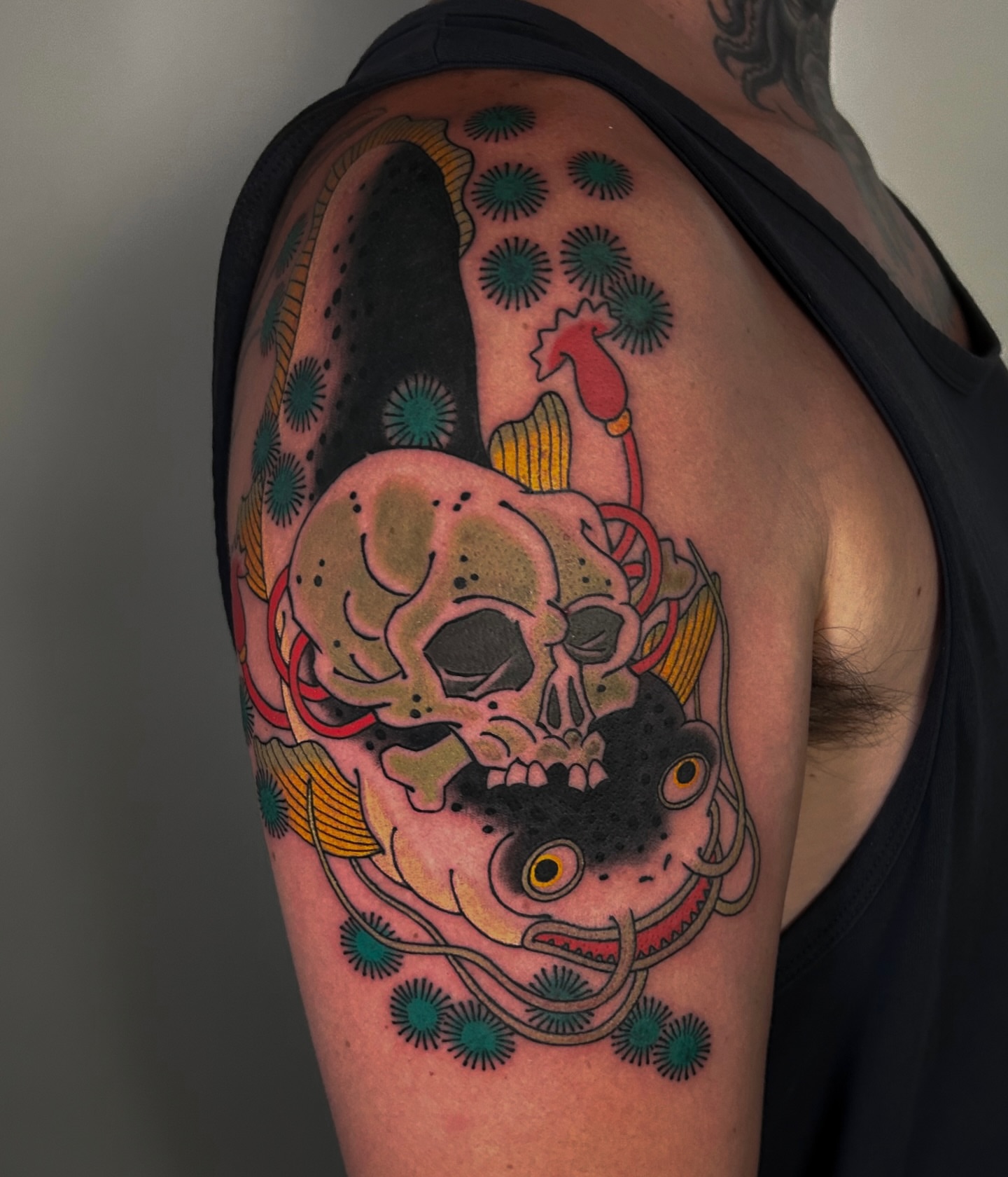 Skull and tentacle trash polka tattoo on the shoulder by zak brochu, Windsor, Ontario