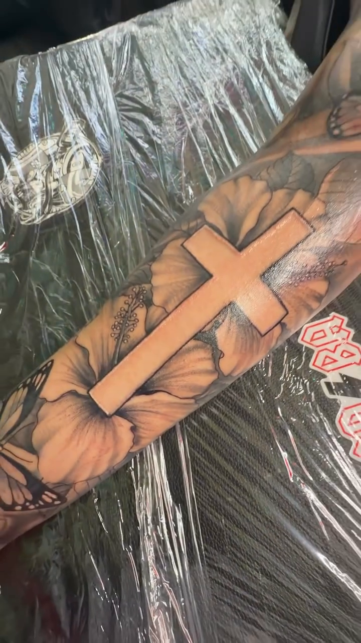 Cross with sunflowers fine line tattoo on the upper arm by DOE๐๐น