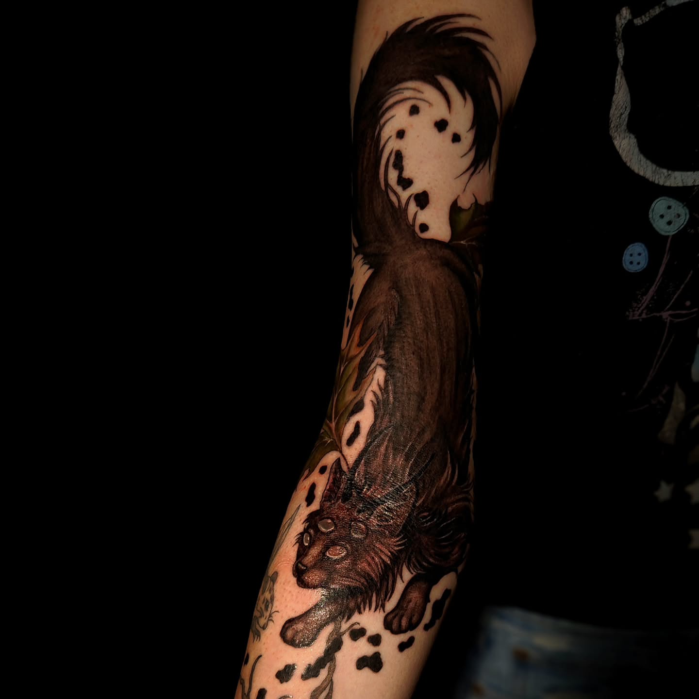 Lion and dalmatian realism tattoo on the forearm by Ashly Renee