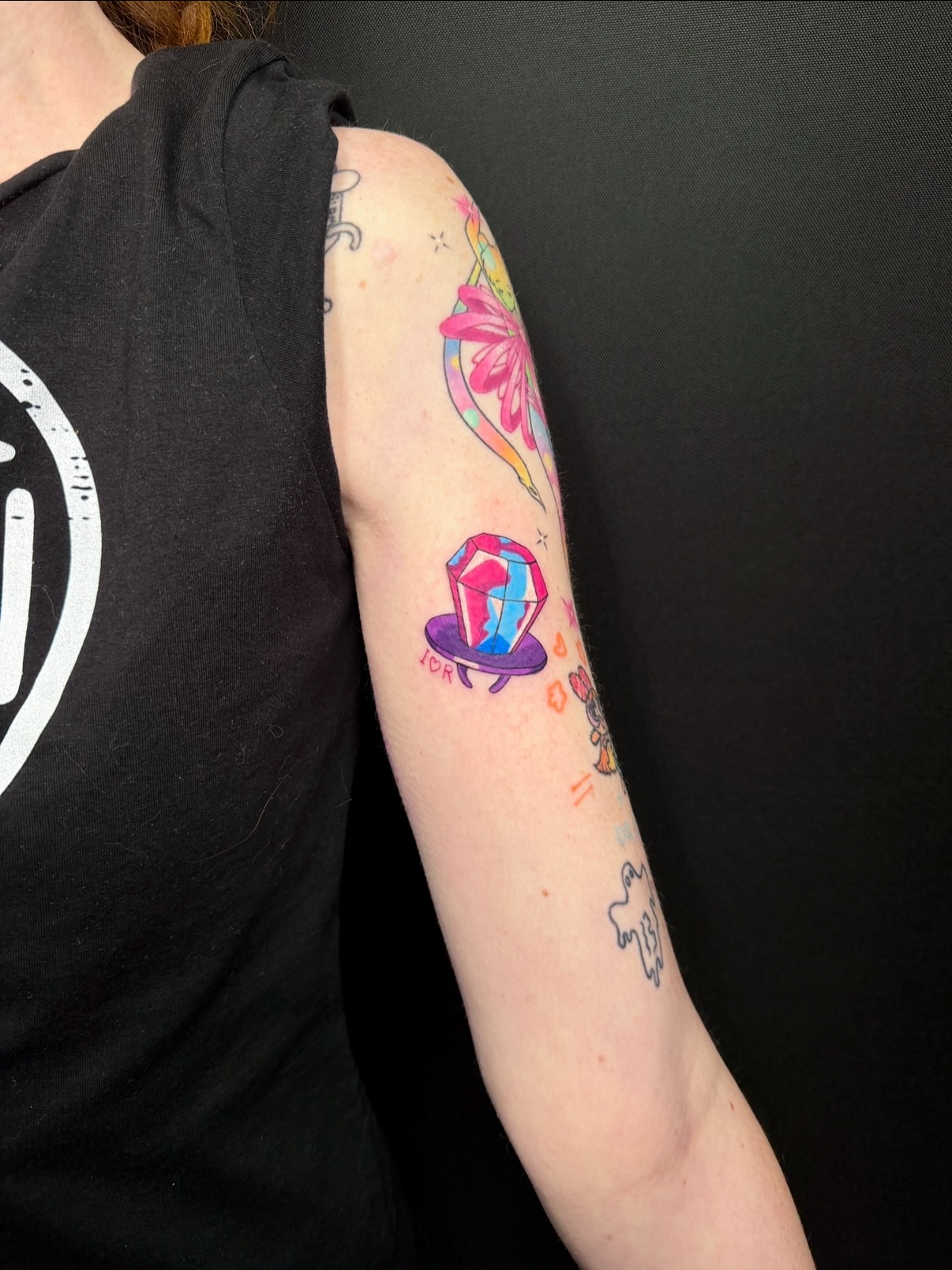 Gemstone and flower new school tattoo on the forearm by aria, Austin, Texas