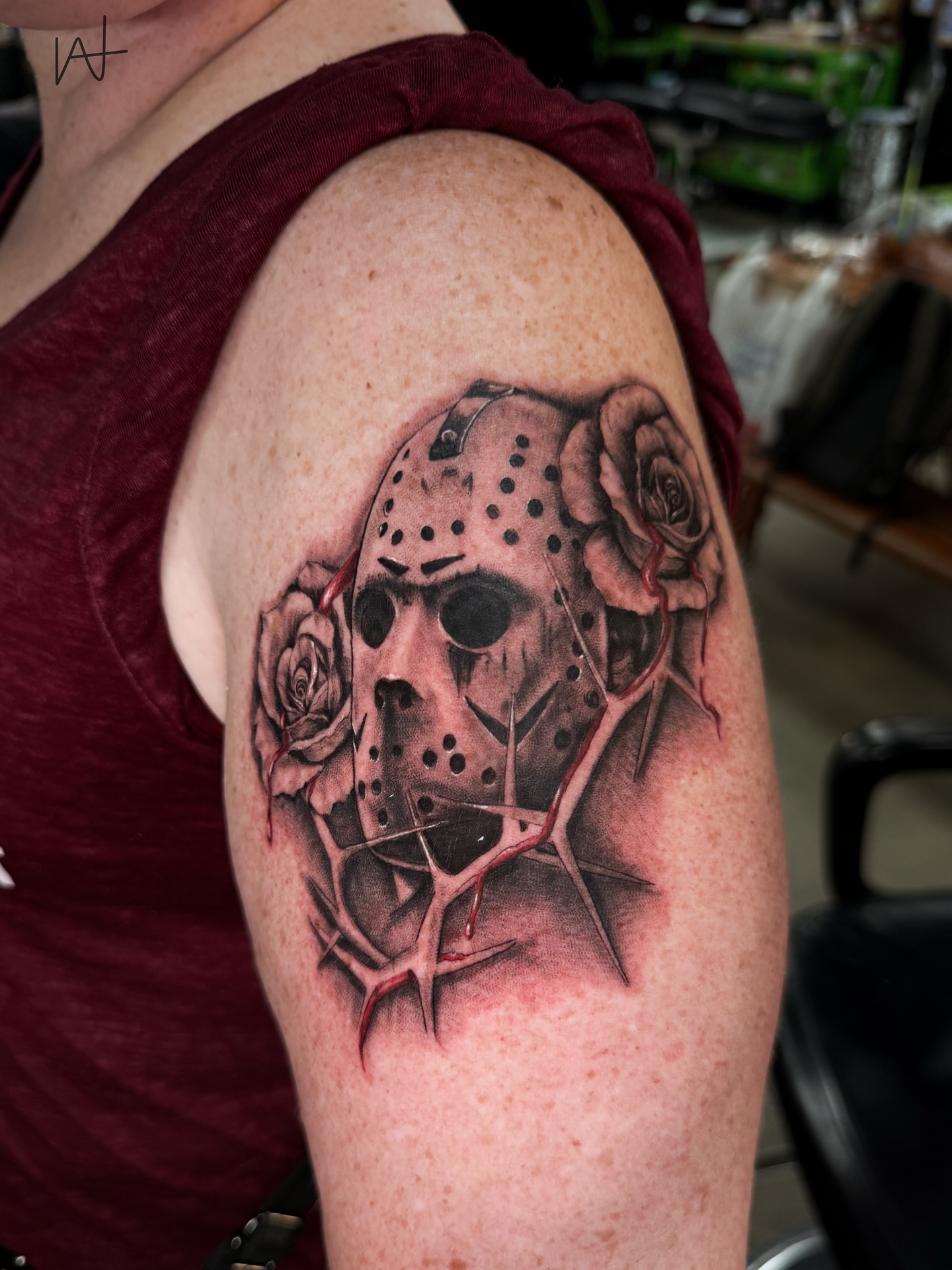 Jason mask with roses realism tattoo on the shoulder by Kat Parmu