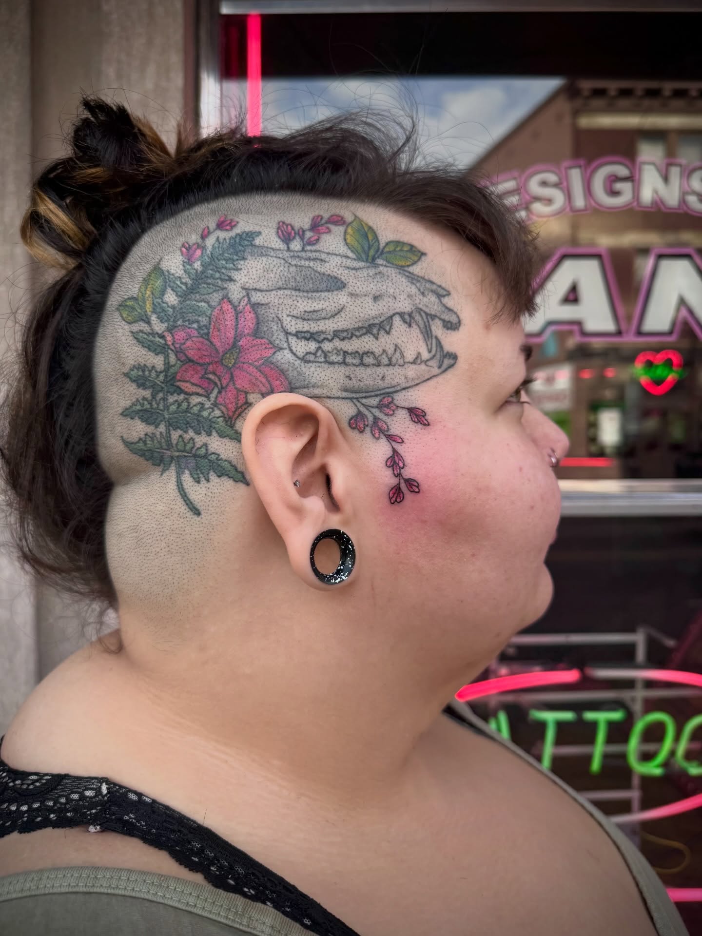 Skull with floral elements dotwork tattoo on the head by Kylie Allen