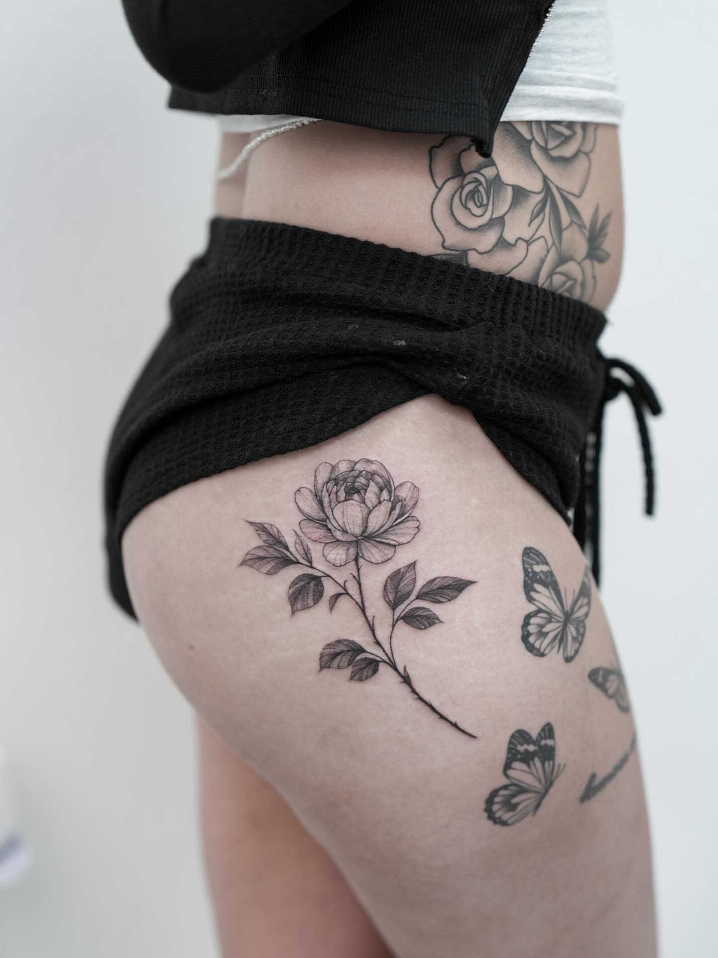 Peony and butterflies black and grey tattoo on the thigh by New Root Ink _Studio