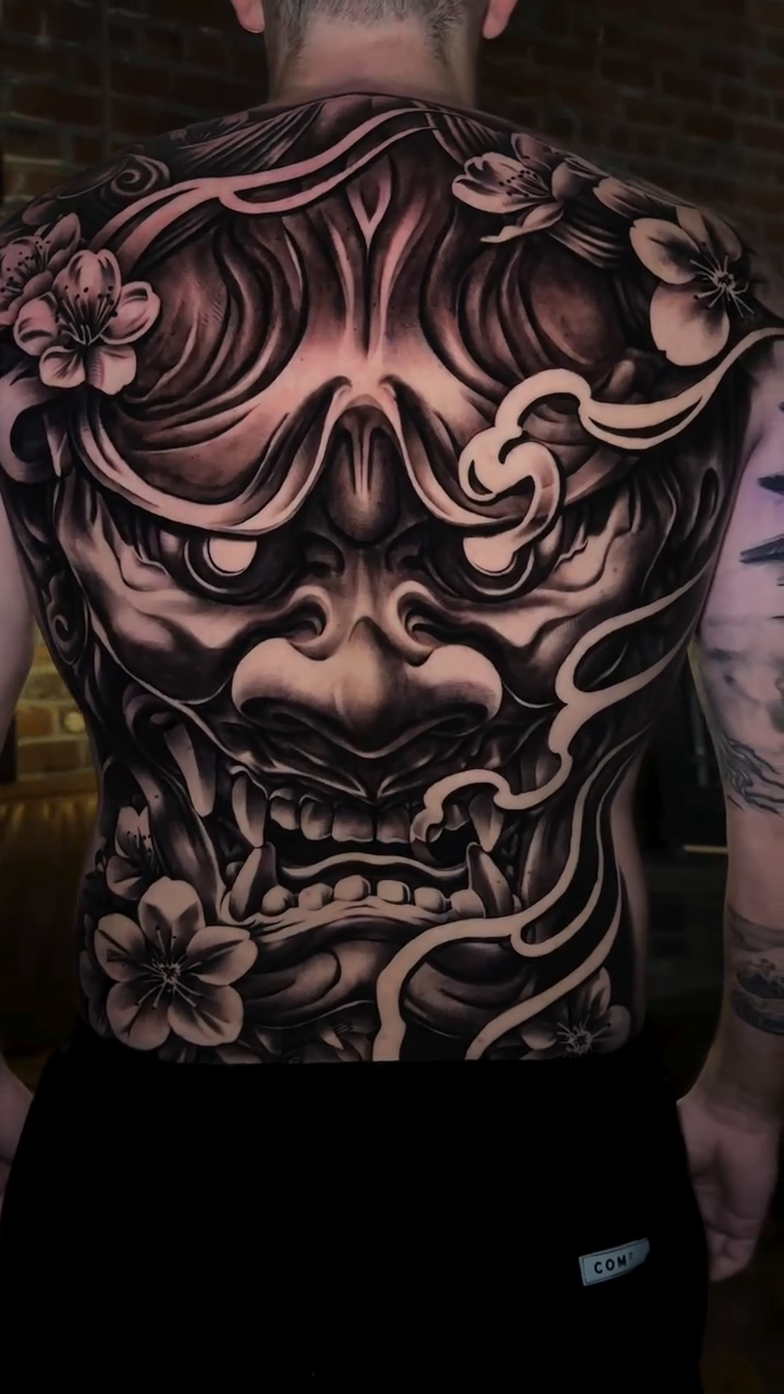 Oni mask and flowers japanese irezumi tattoo by 𝐉𝐨𝐧 𝐒𝐚𝐧𝐭𝐨𝐬