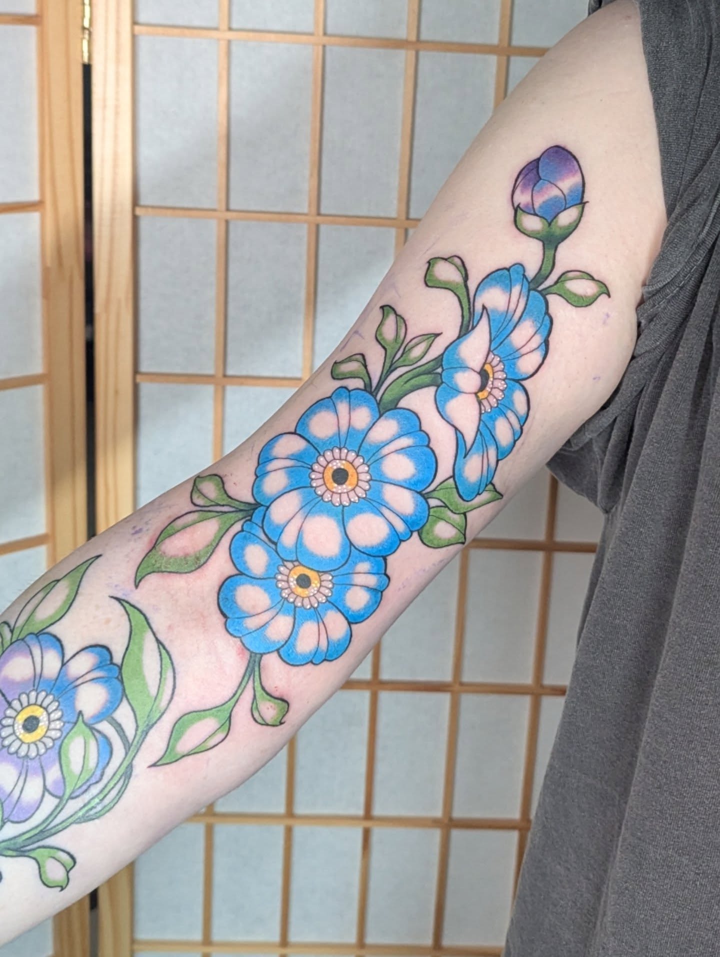 Blue flowers new school tattoo on the forearm by Nico Capriotti ๐ณ๏ธโ๐
