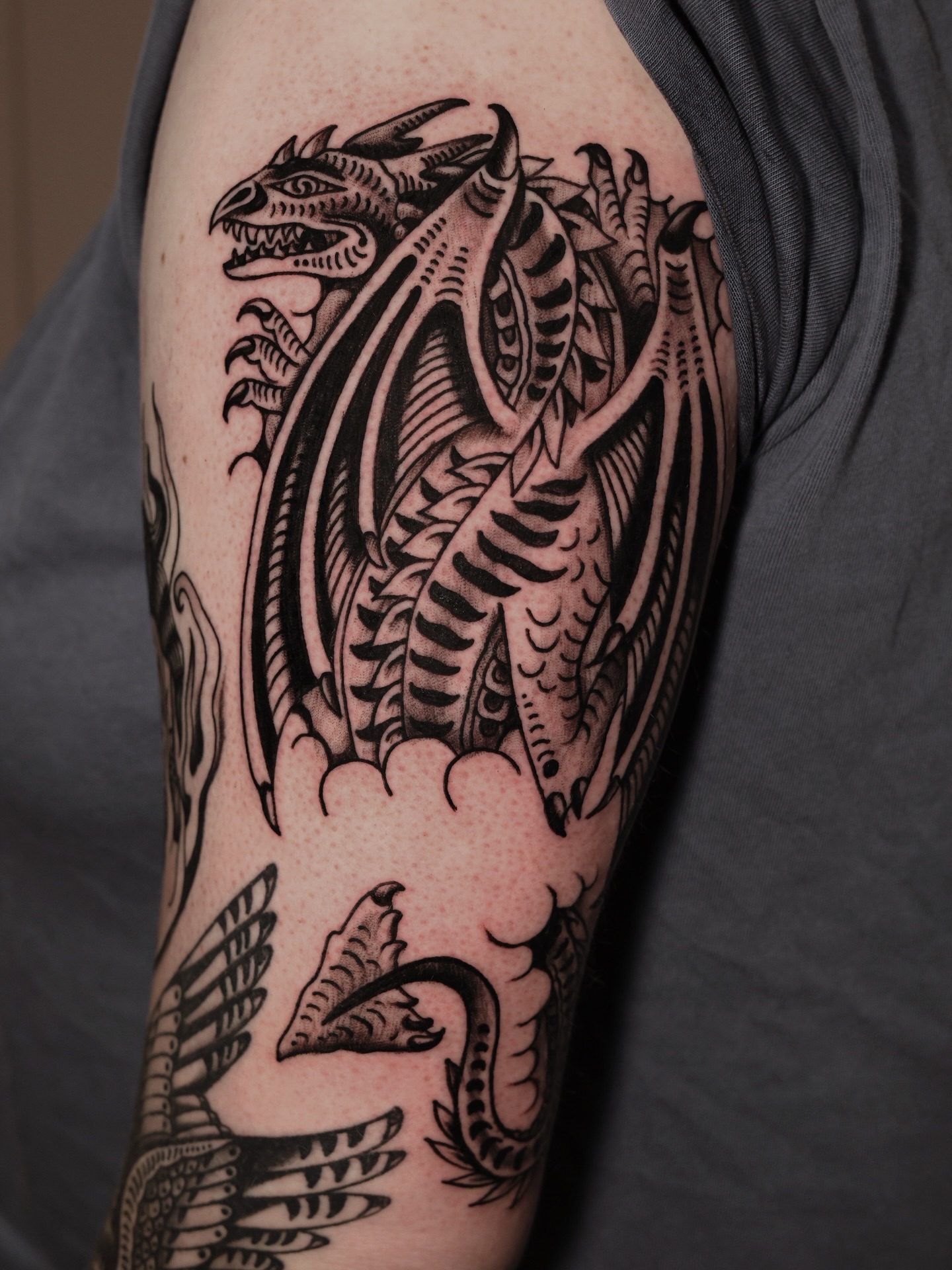 Dragon black and grey tattoo on the forearm by Dylan Mott
