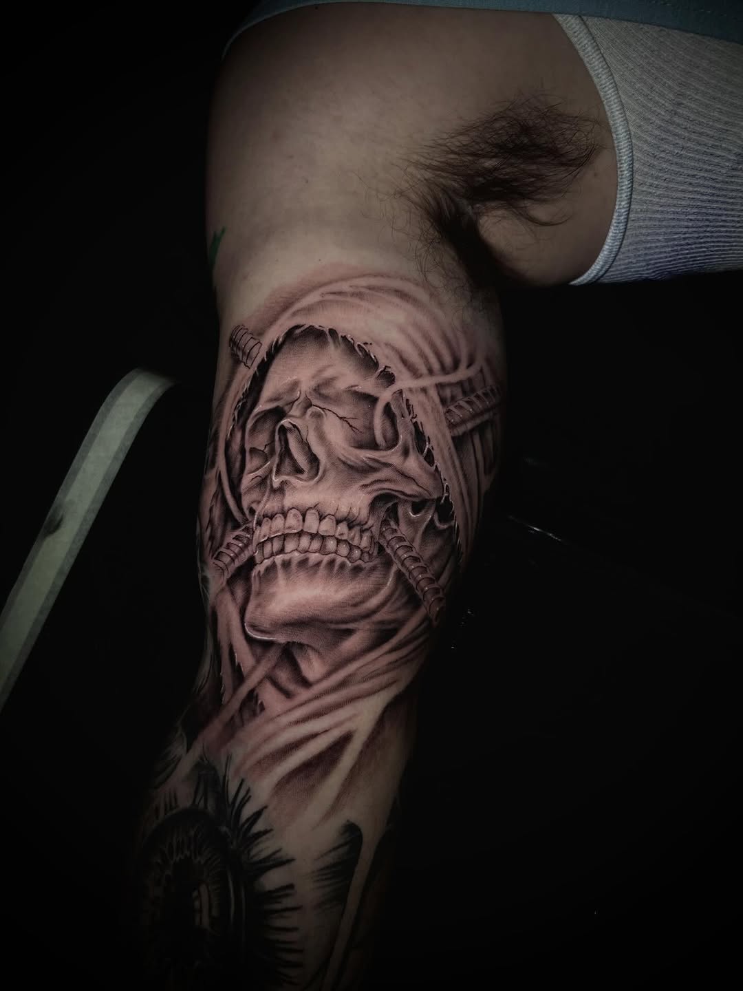 Skull with cloth and wires realism tattoo on the forearm by Dylan Stevens
