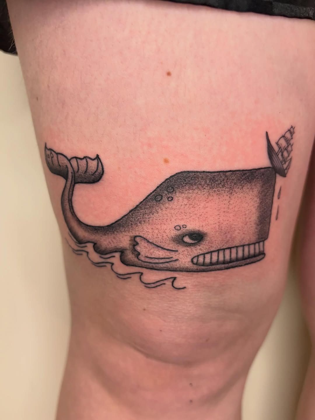Whale with ship fine line tattoo on the thigh by Fin :