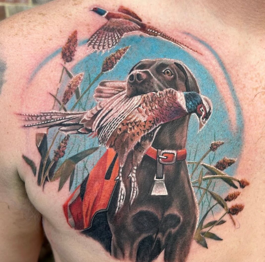 Dog with pheasant realism tattoo on the back by Adam Zgorliski_STStattoo