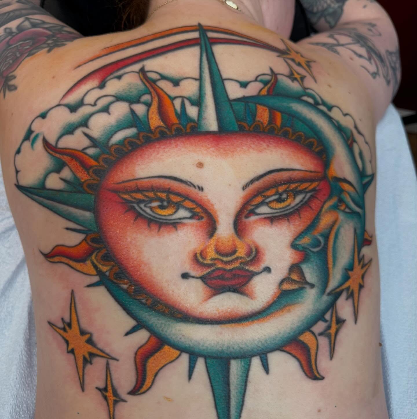 Sun and moon American traditional tattoo on the chest by Mikaila Rose Krauss