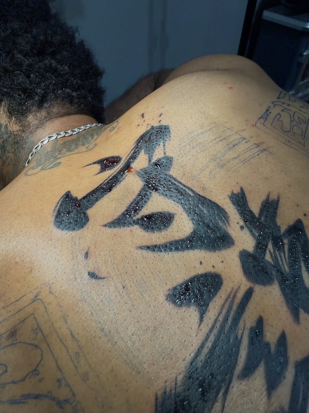 Kanji character tattoo on the back by German Patiño.
