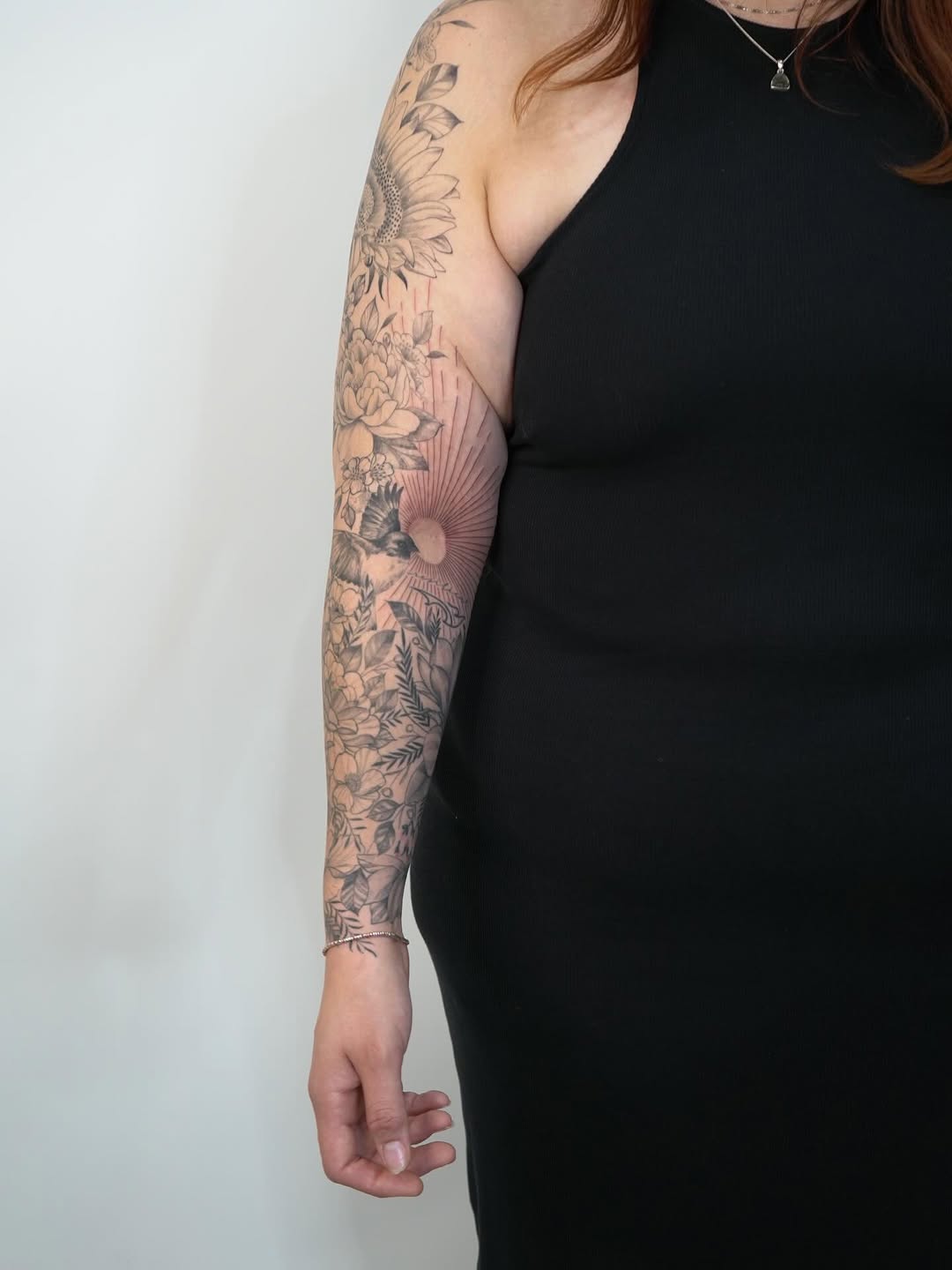 Floral sleeve with sun and bird fine line tattoo on the forearm by Pedro D Gamez