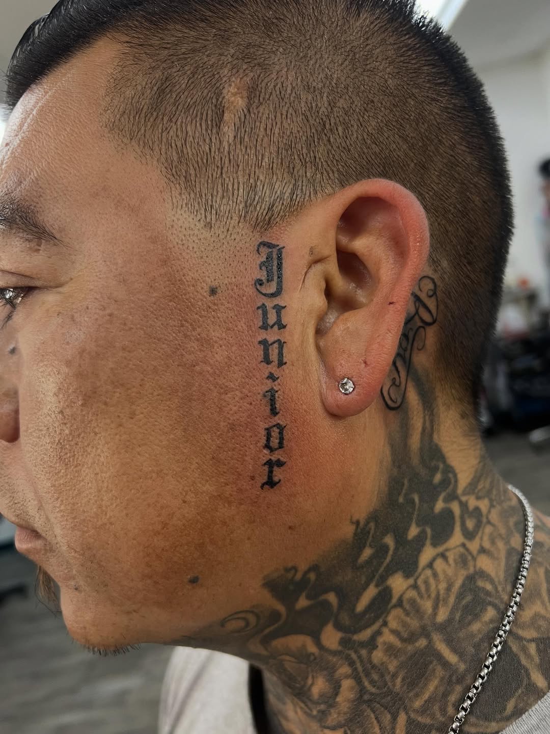 Vertical lettering on face Chicano tattoo on the neck by Renzoe_piercingz