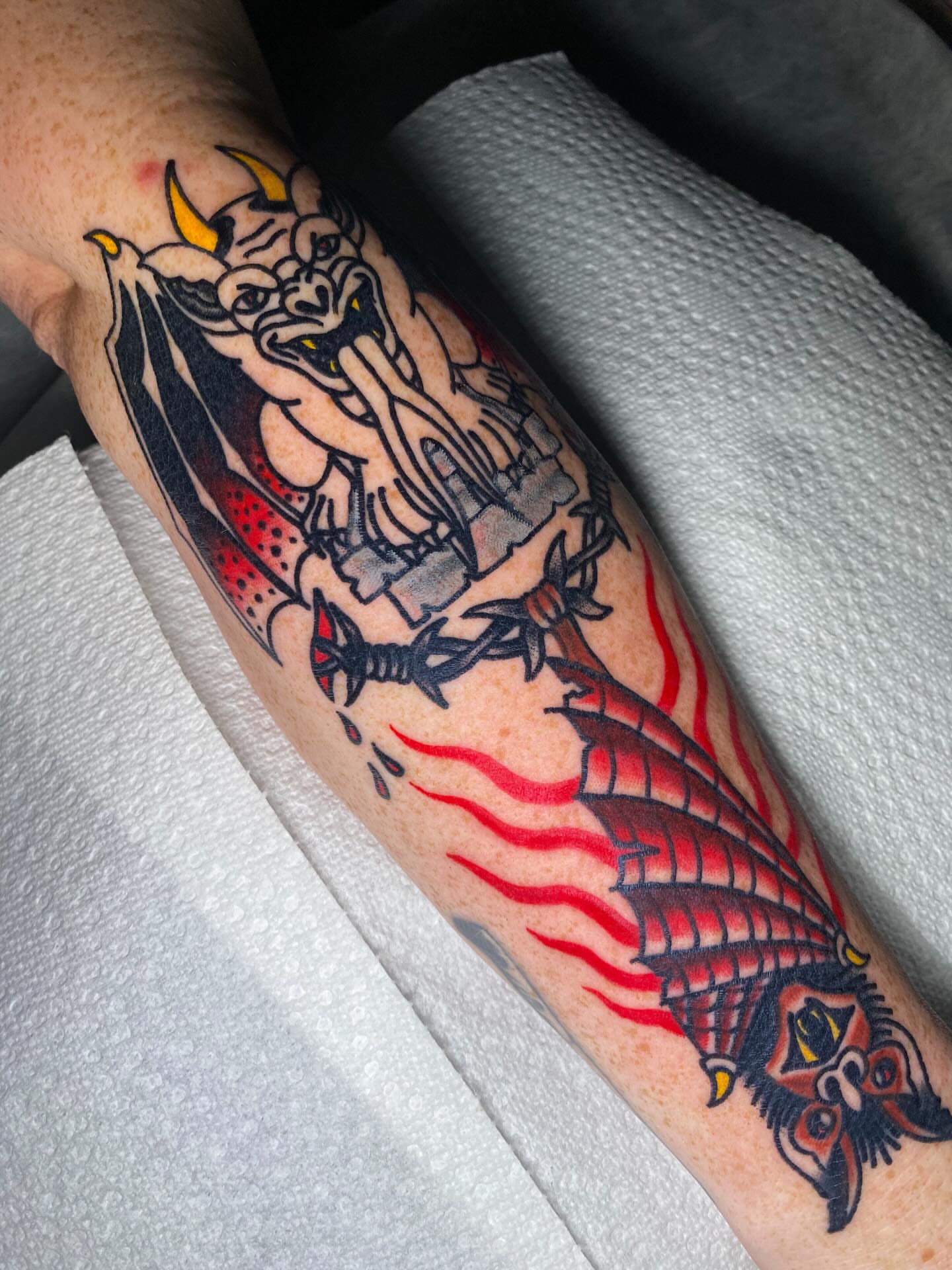 Demon and dragon American traditional tattoo on the forearm by Nosferatu