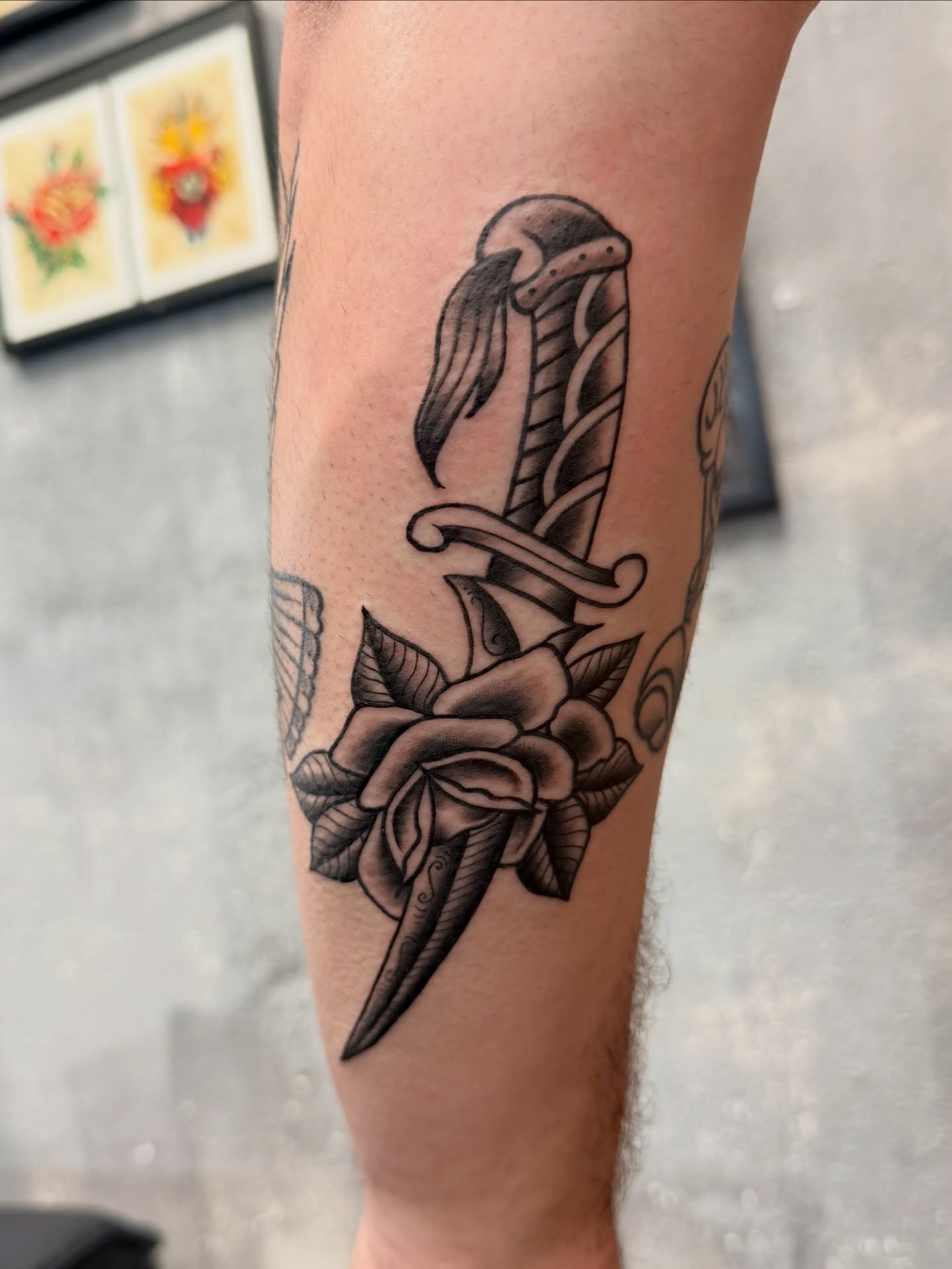 Sword and rose American traditional tattoo on the forearm by Chris