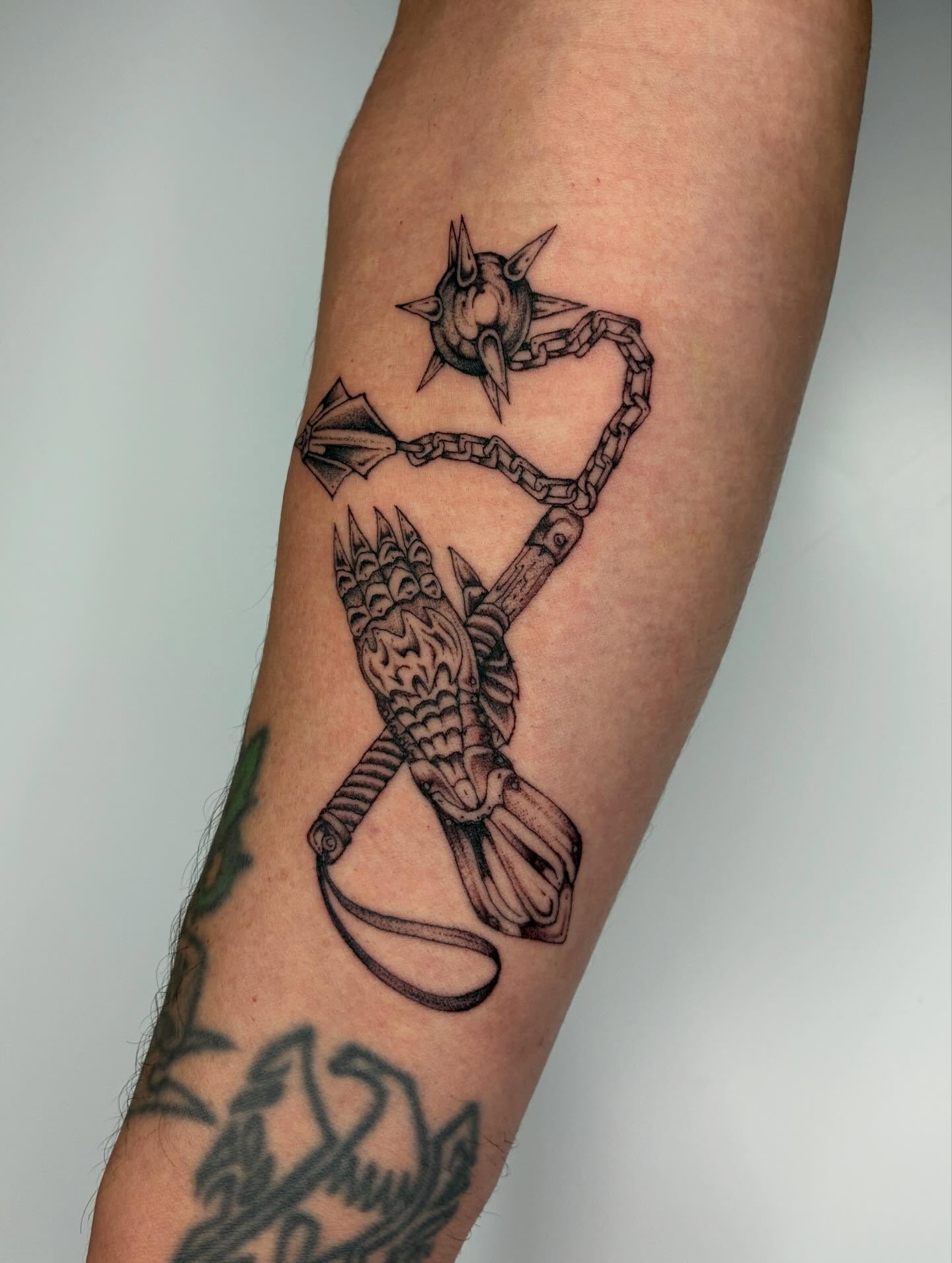Chain and bird black and grey tattoo on the forearm by Steven Sessler, San Francisco, California