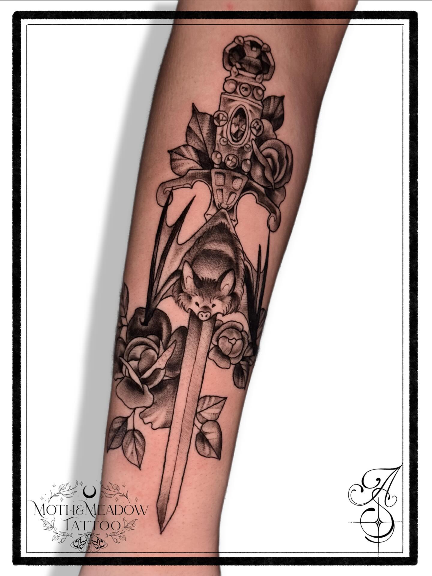 Bat and roses realism tattoo on the forearm by Ash Sansoucie