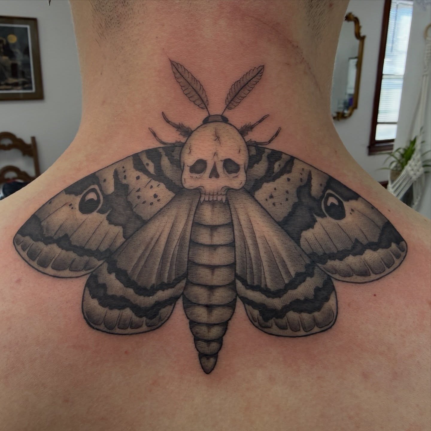 Moth with skull head realism tattoo on the neck by Sania Marquez