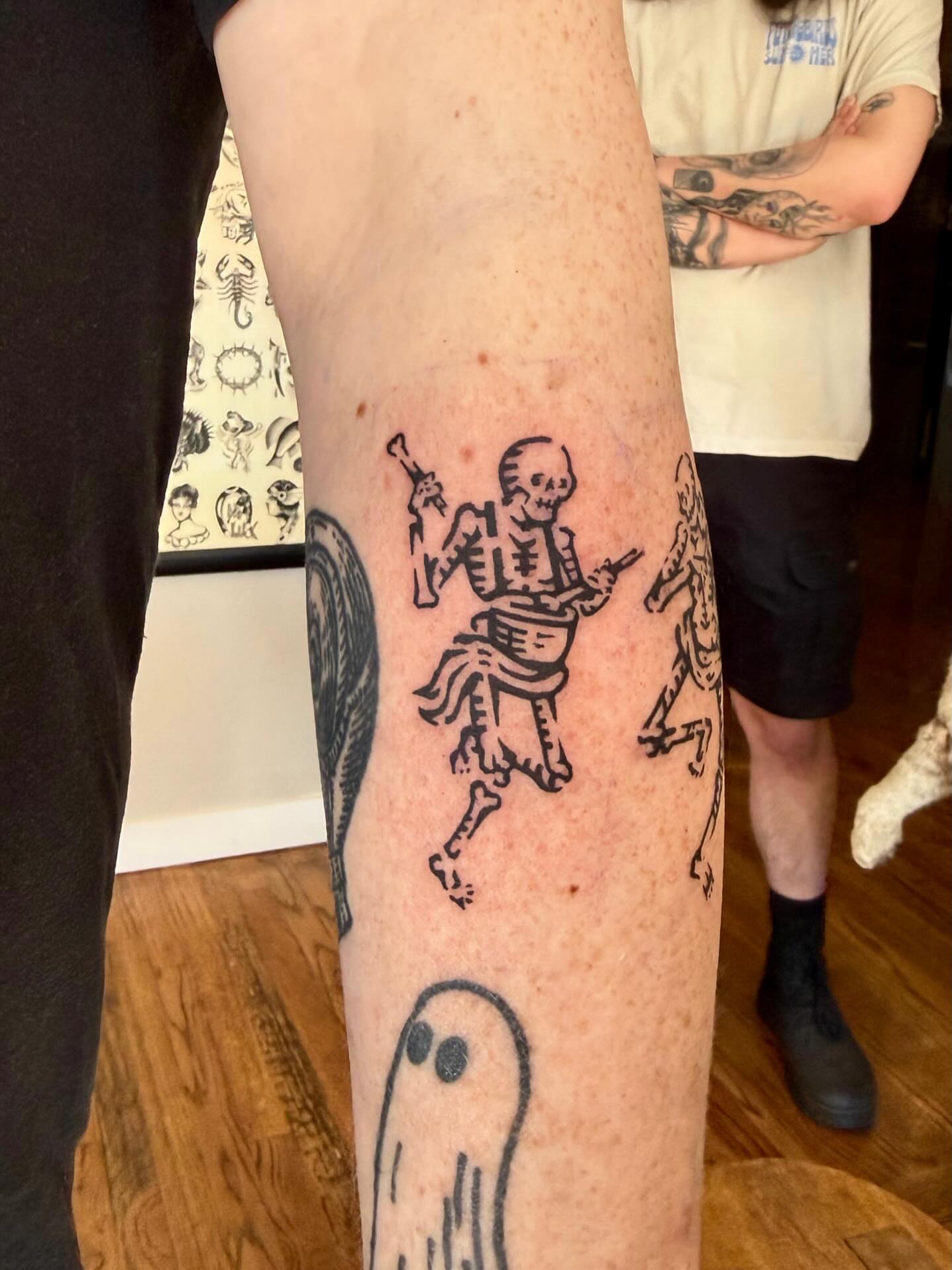 Dancing skeleton American traditional tattoo on the forearm by M