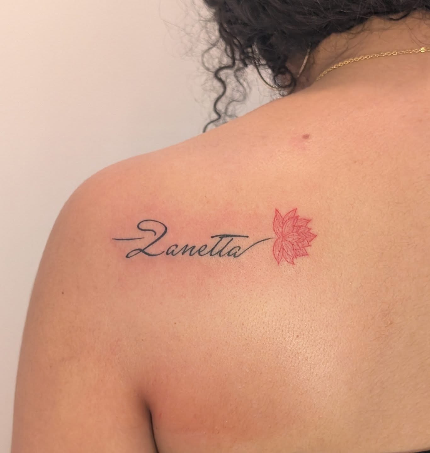 Name with flower lettering script tattoo on the shoulder by Nenookaasi Martin