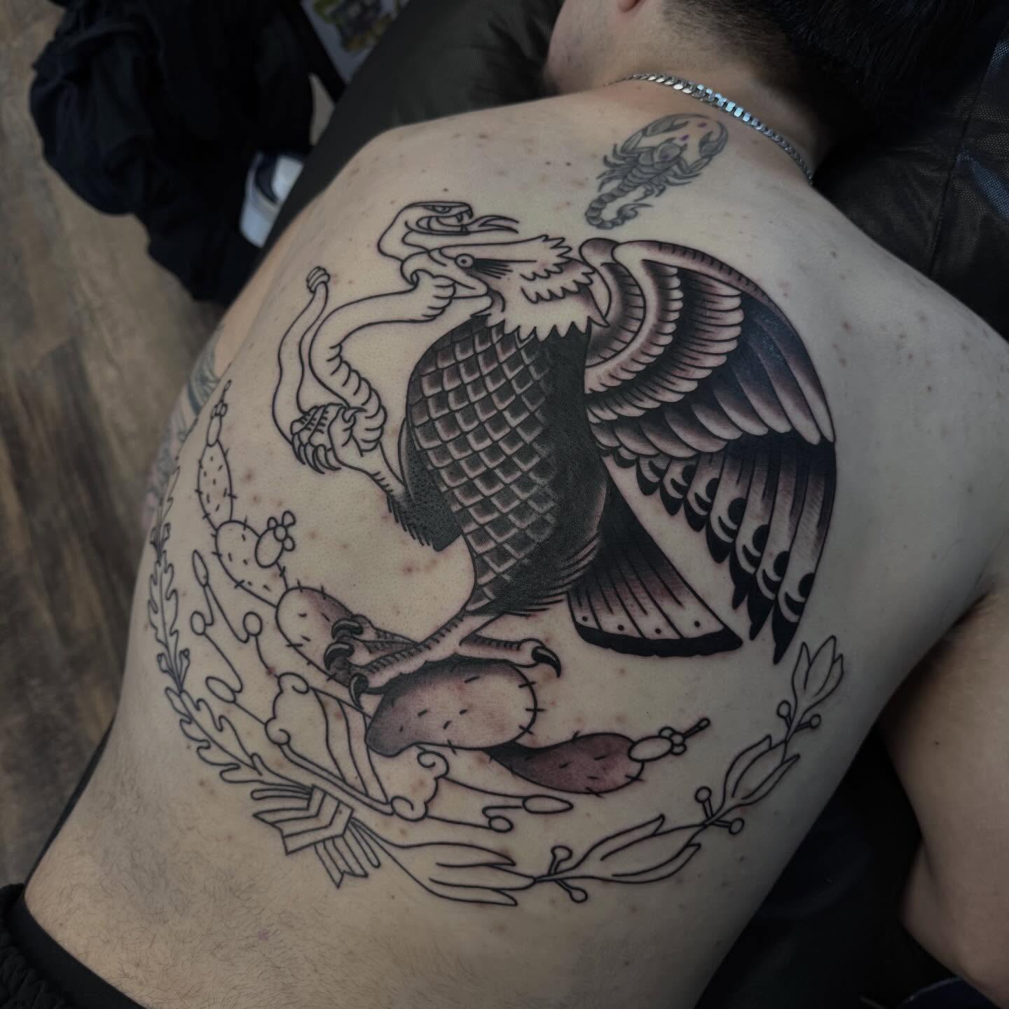 Eagle and snake American traditional tattoo on the thigh by Landon Lewis
