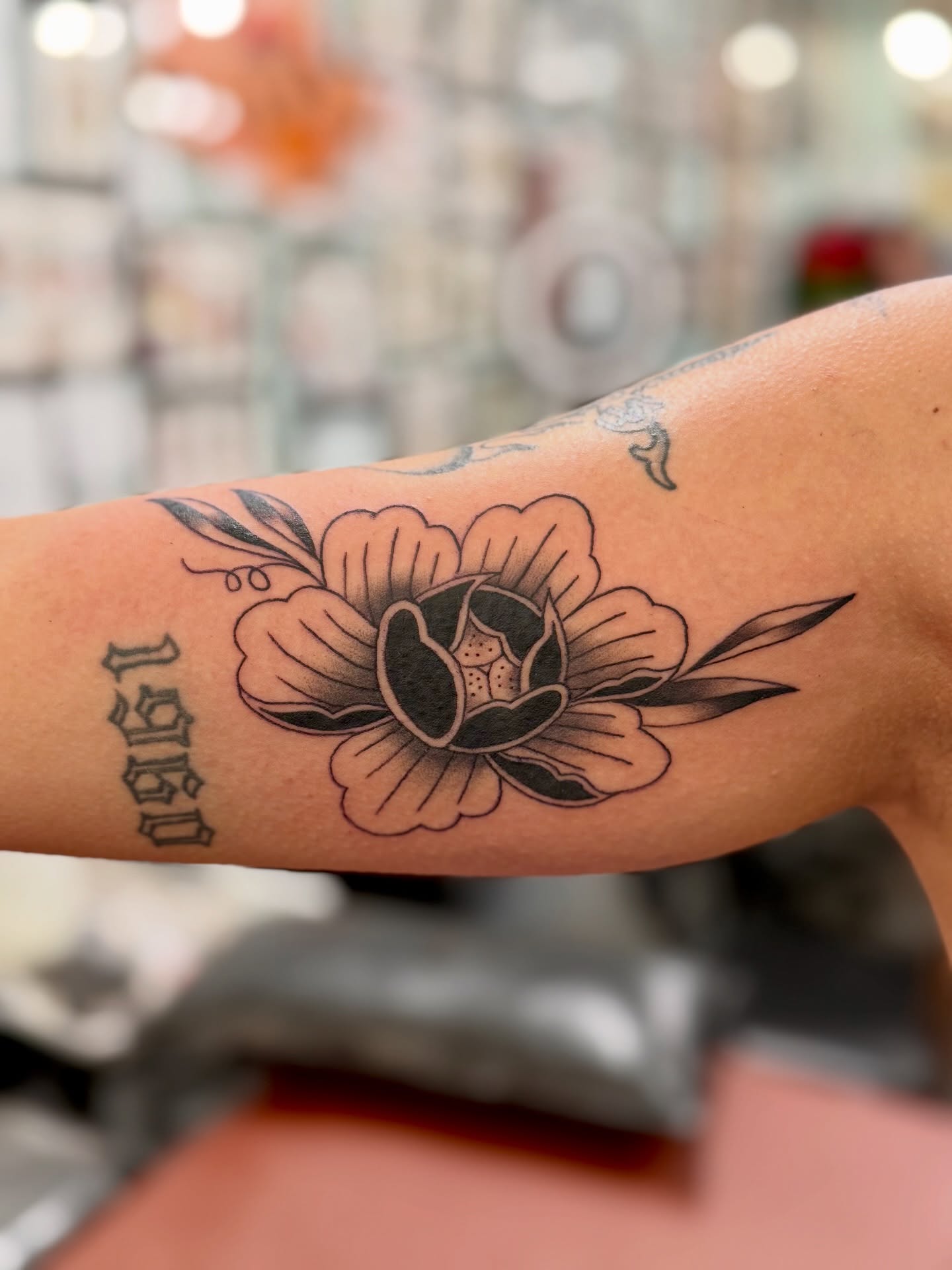 Flower black and grey tattoo on the forearm by Sophie McTear