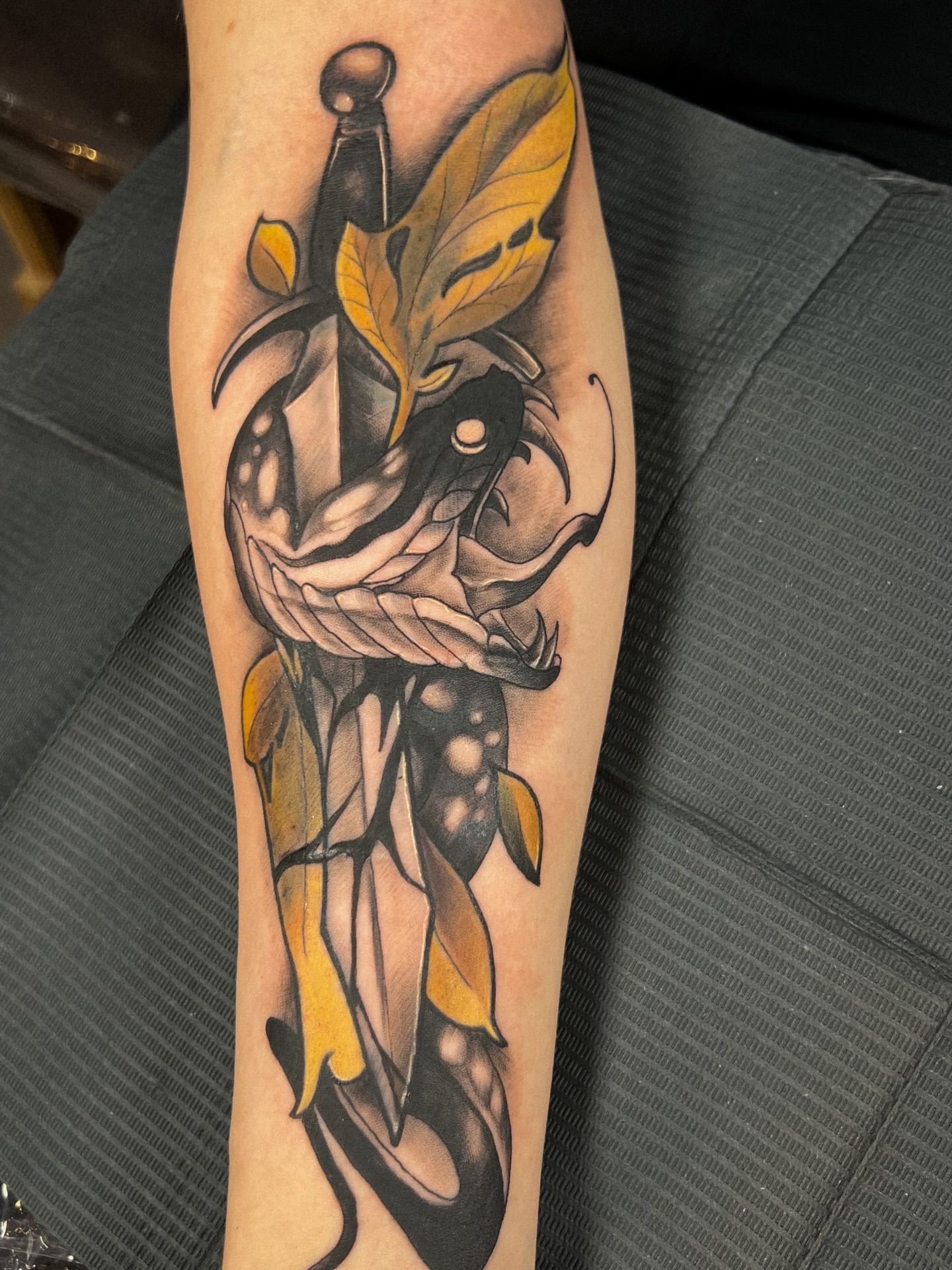Knife and fish American traditional tattoo on the forearm by Asap tattoo