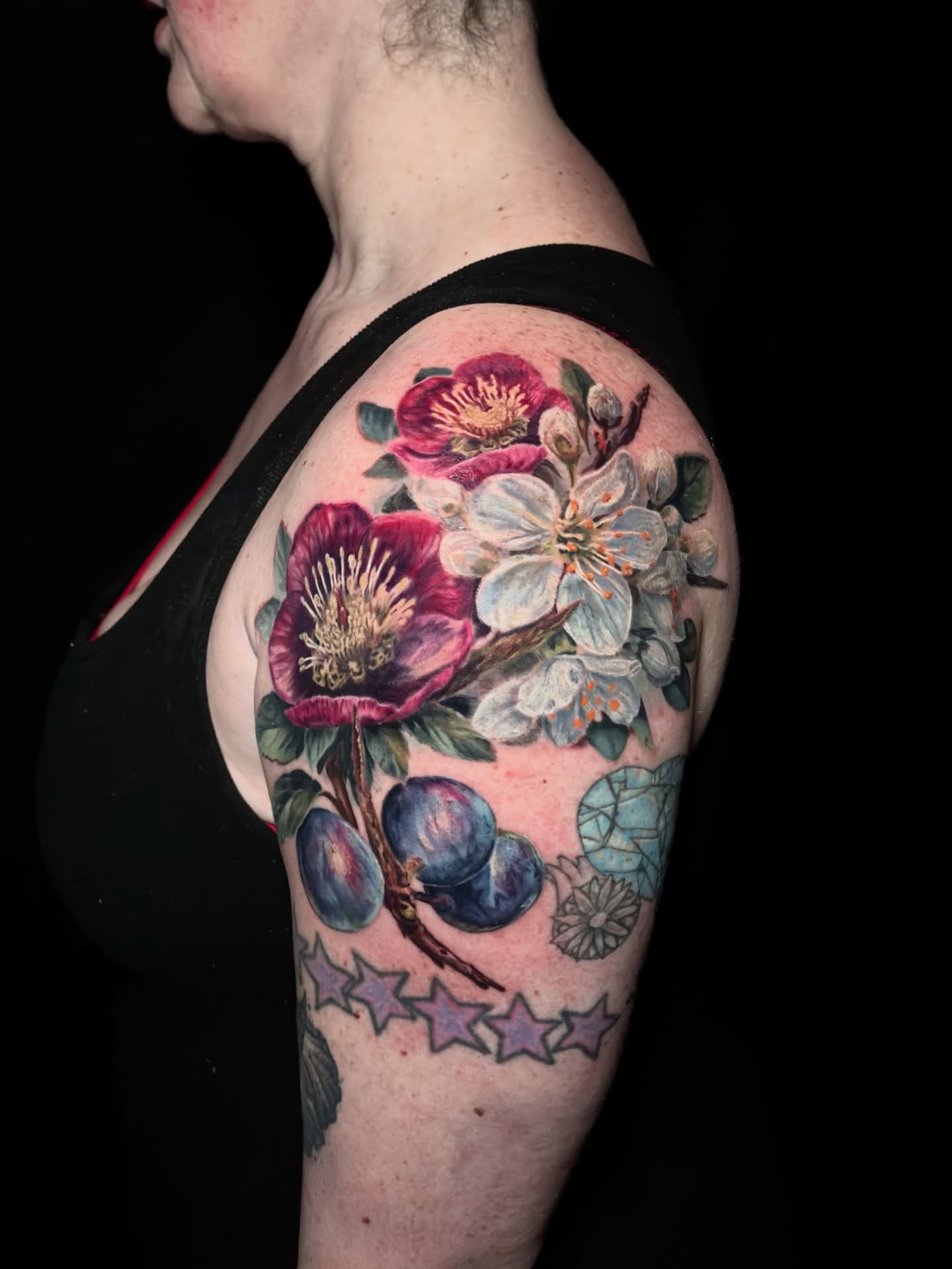 Floral arrangement realism tattoo on the shoulder by Meg Mayhem ๐จ Sarenity Tattoo