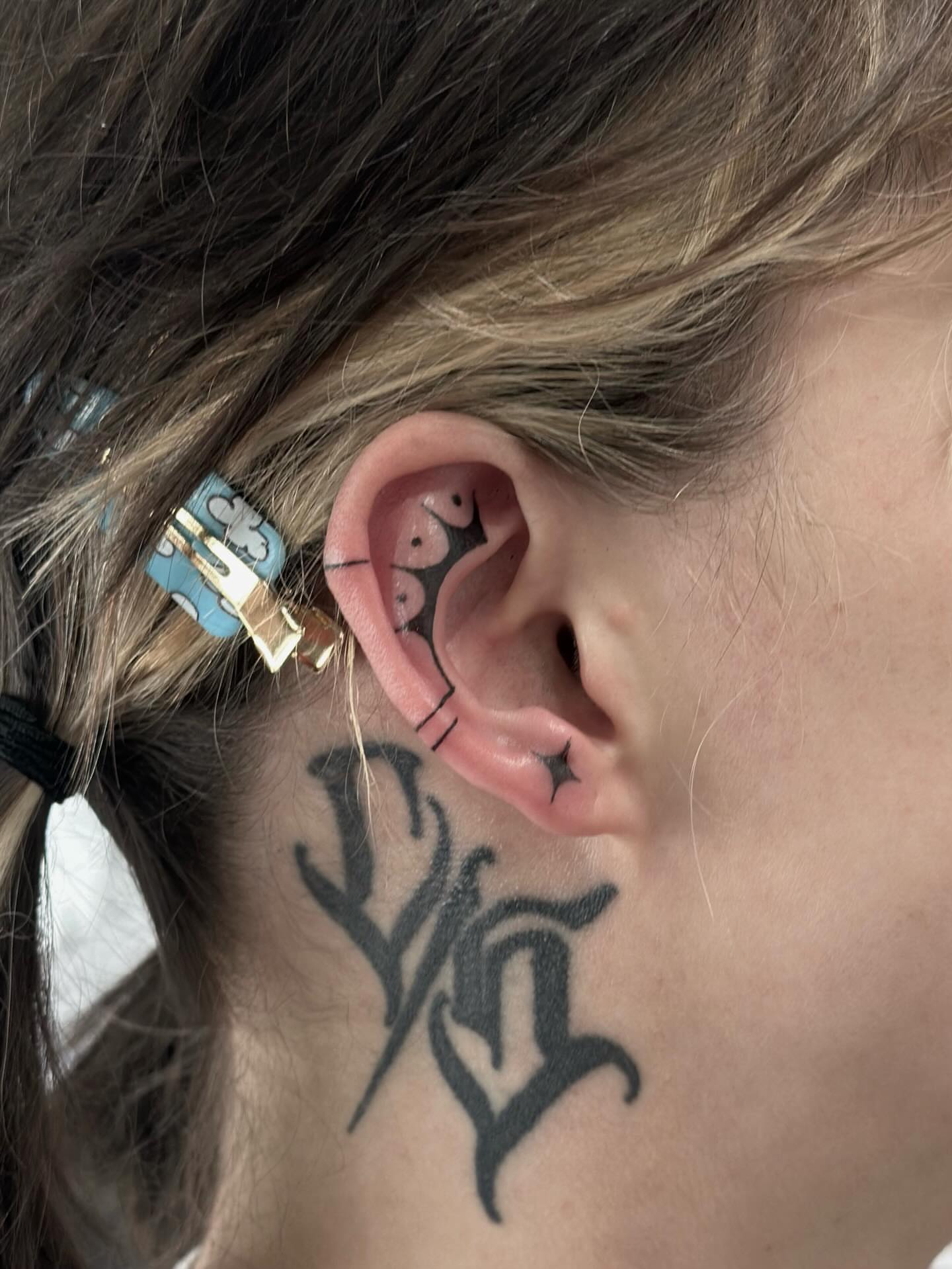 Ear black and grey tattoo on the neck by Kat Fishbein