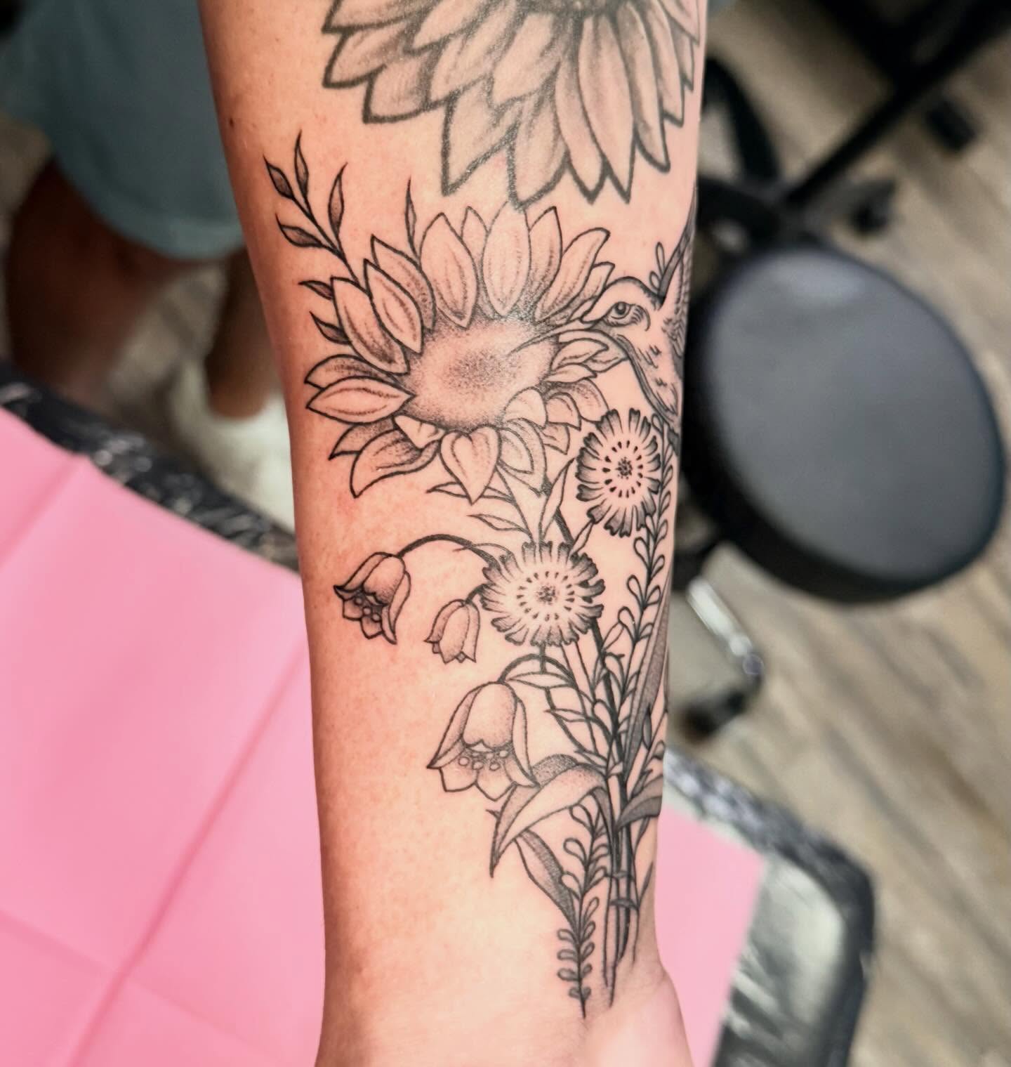Sunflowers and wildflowers black and grey tattoo on the forearm by mia christensen